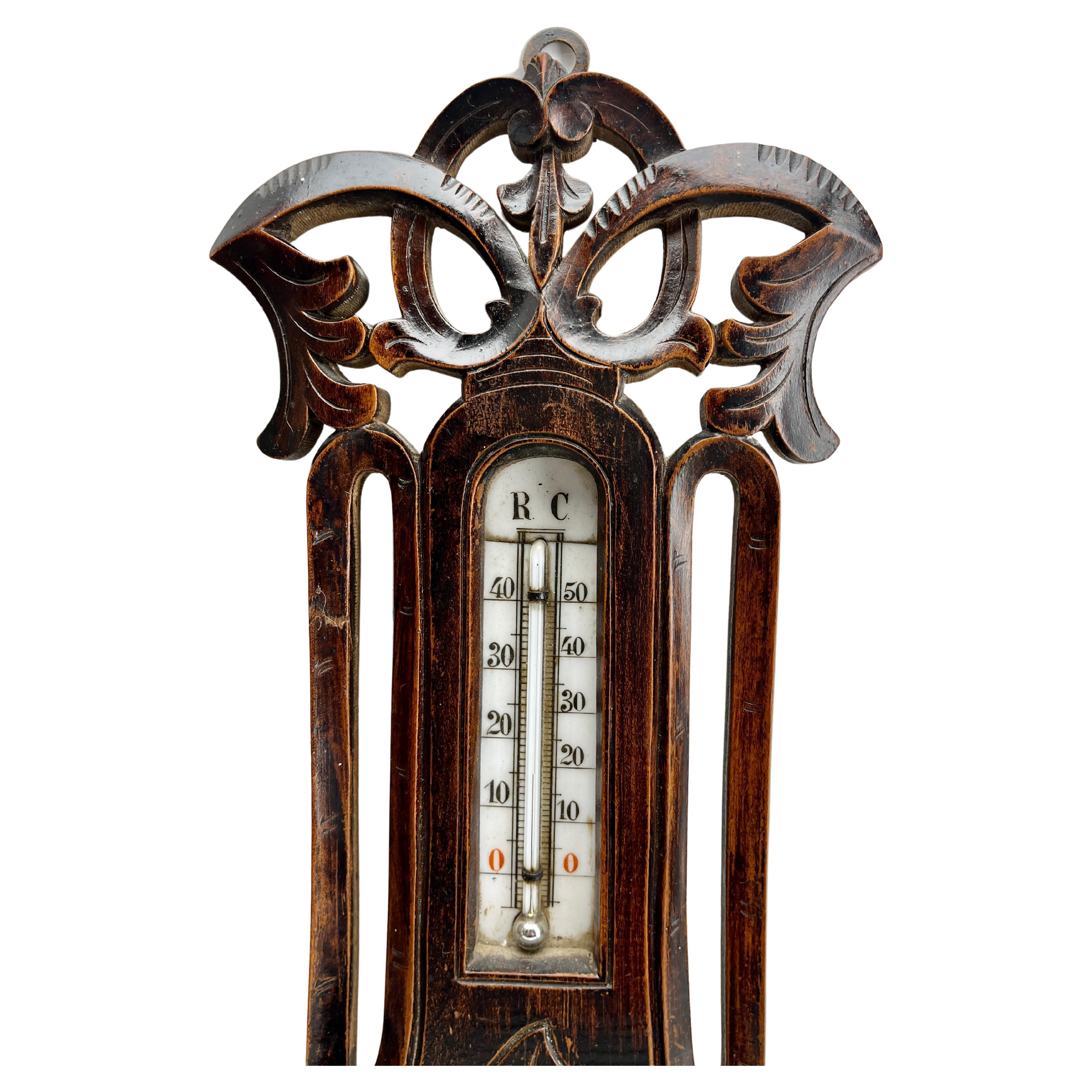 Wall-mounted weather station in carved walnut made in Spa Belgium by Valentine Engel
High quality mechanism with Jeweled movement barometer and thermometer (in centigrade)
Unusual design with high relief C-scrolls and flowers in Rococo style (from