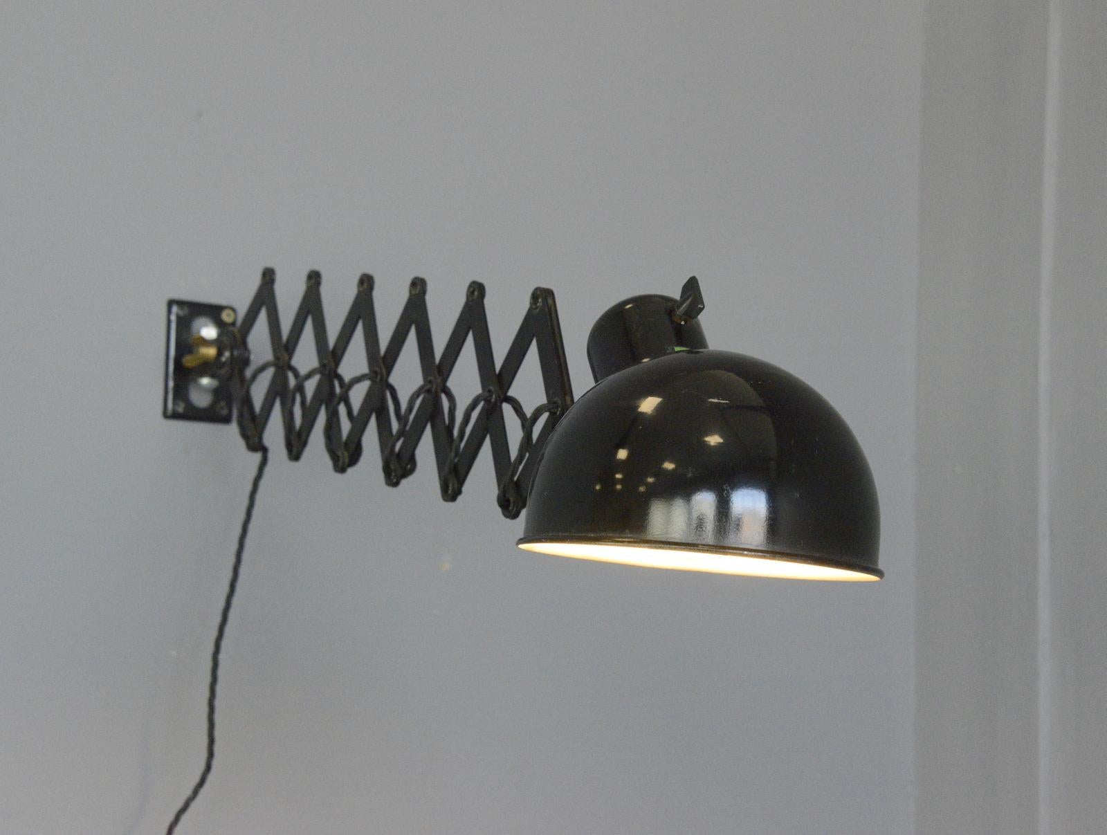 Wall-mounted scissor lamp by Koranda, circa 1930s

- Extendable scissor mechanism
- Takes E27 fitting bulbs
- Designed by Christian Dell for Koranda
- Austrian, 1930s
- Size: 17cm wide 
- Extends up to 90cm from the wall

Condition