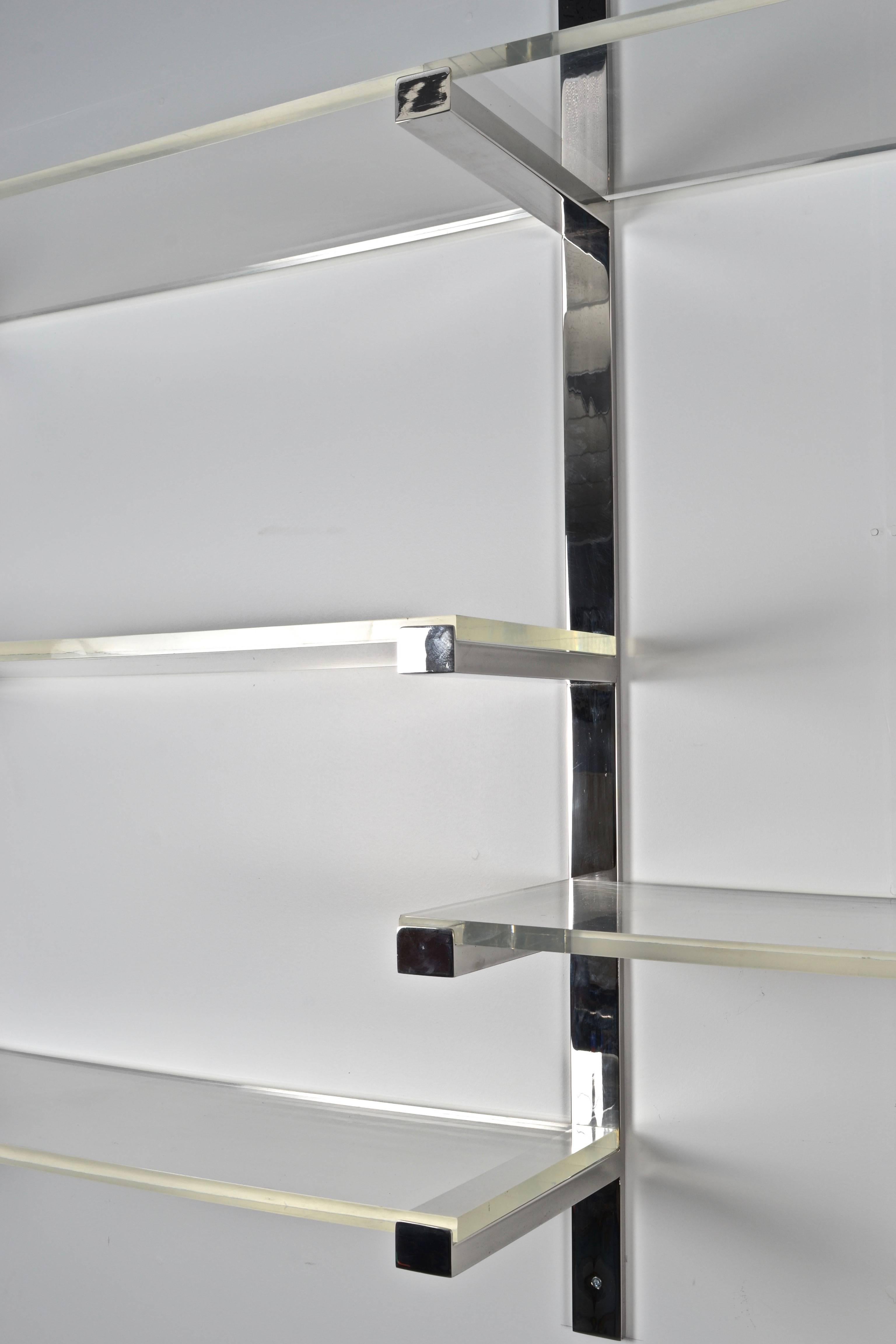 Chrome wall-mounted brackets support thick Lucite shelves. Excellent quality construction and finishing. Fine vintage condition. Steel has been professionally polished. Lucite is clean with very, very light surface scratches only.