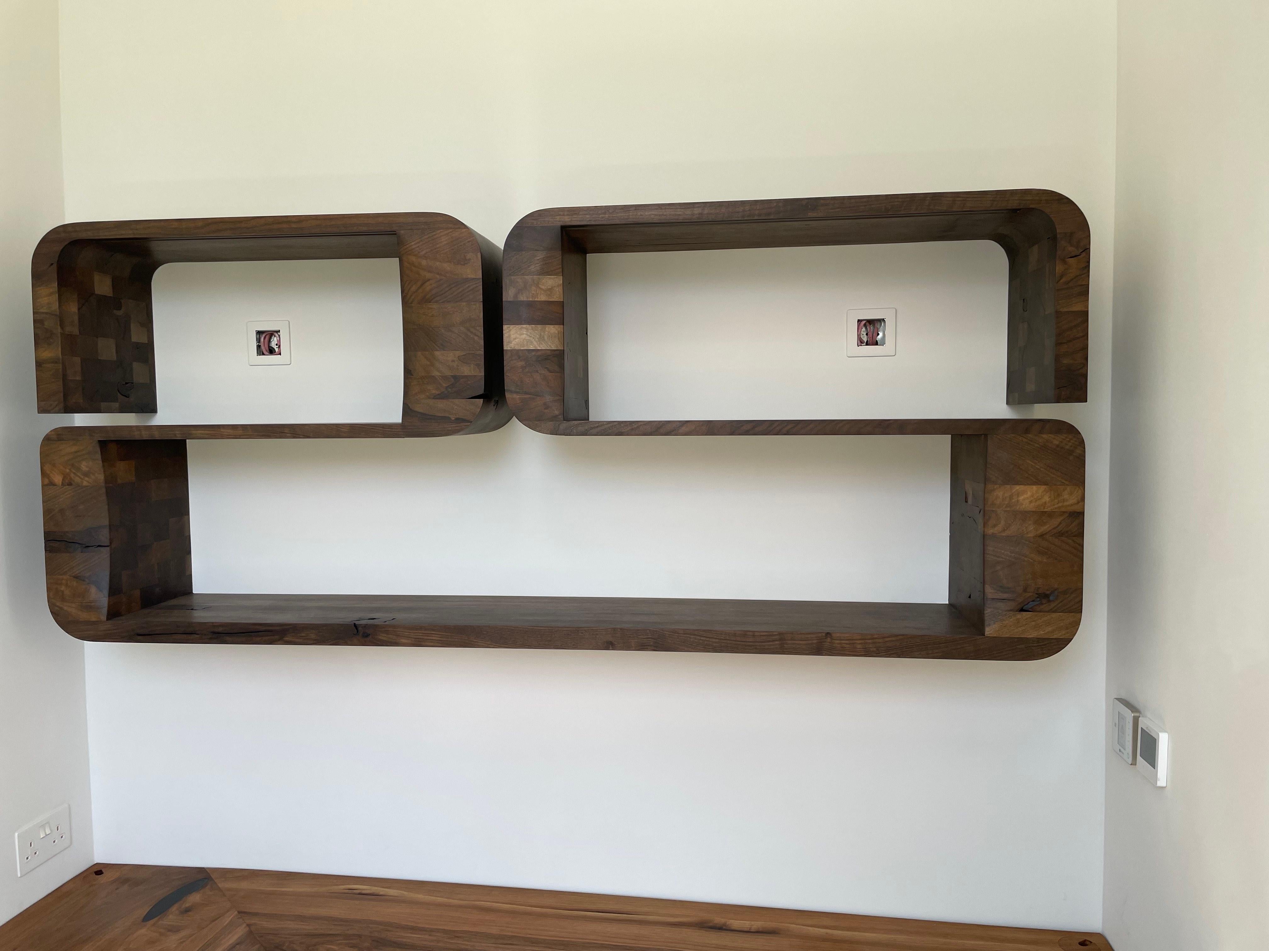This wall-mounted shelving unit was part of a design project commissioned for a private client's home office.
There is allowance for electric cabling to run from the back to the front for concealed LED lighting along the underside of the front