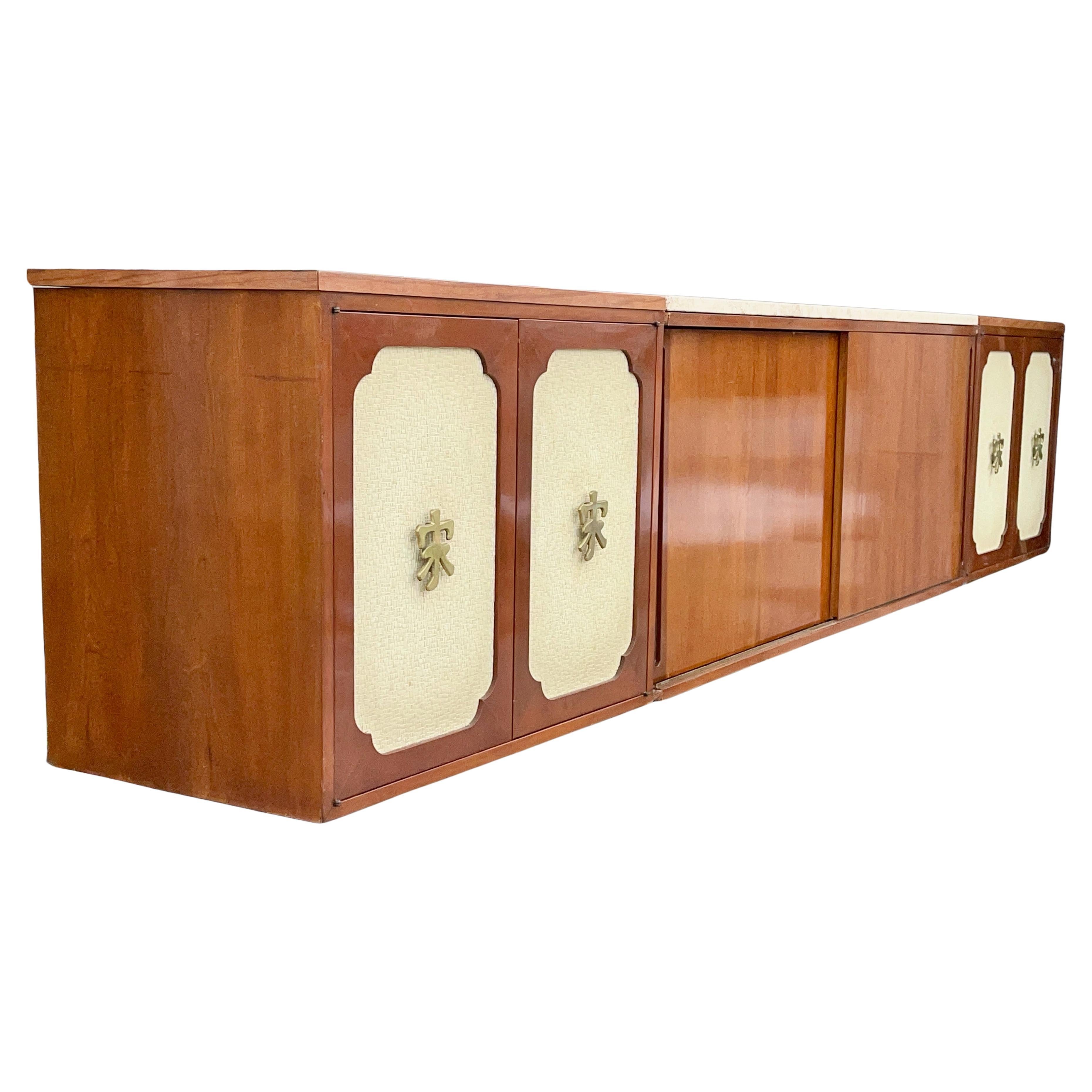 Custom built mid-century modern Hollywood Regency wall mounted floating sideboard in three separate sections which appear as a single ten feet long unit. 
Overall dimensions 24
