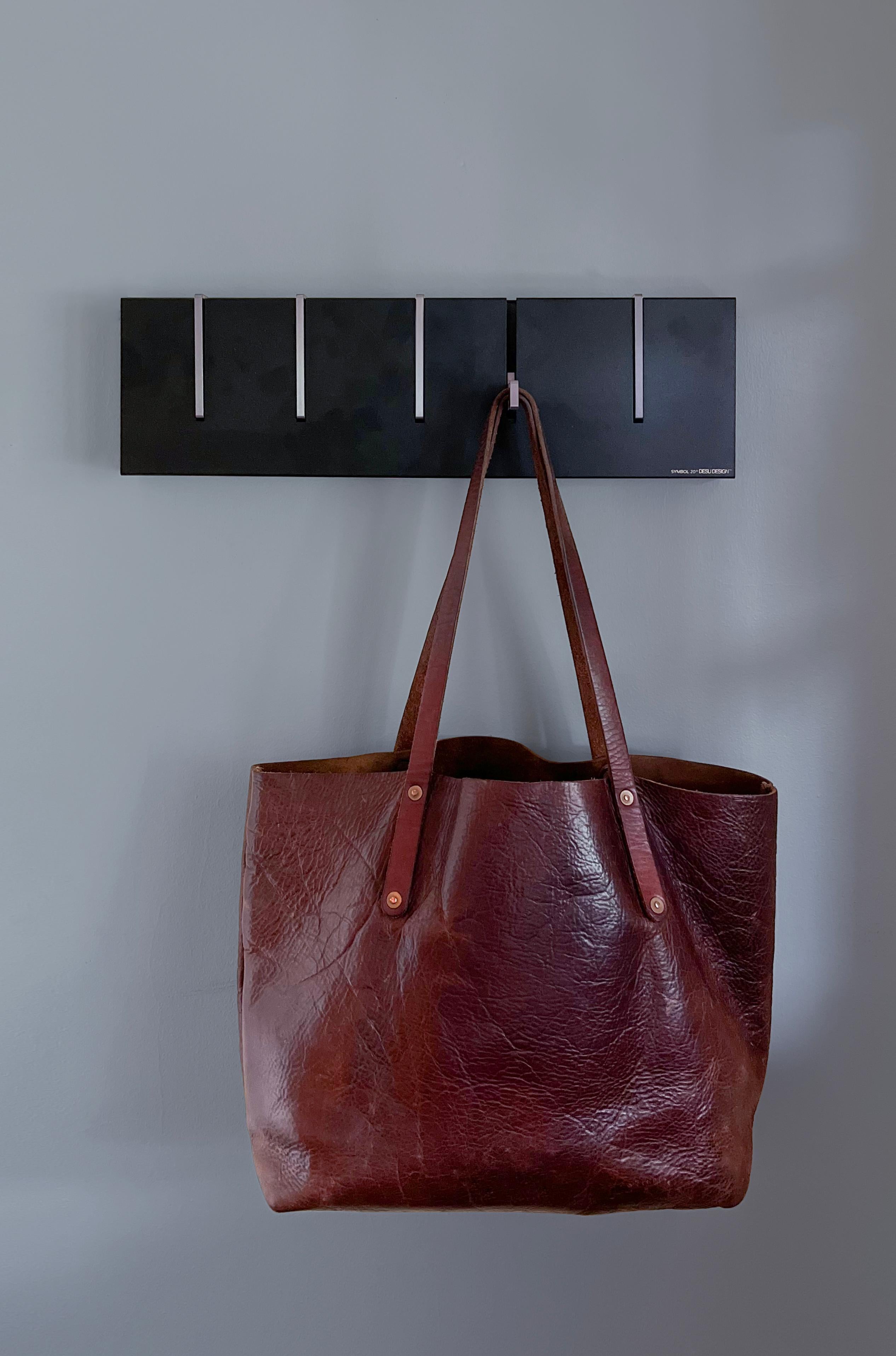 The Symbol 20 offers everything our classic symbol coat rack does, now in a shorter length to fit in more places. This modern coat rack functions both a practical storage option and as wall art. During the summer months the Symbol 20 in color hangs