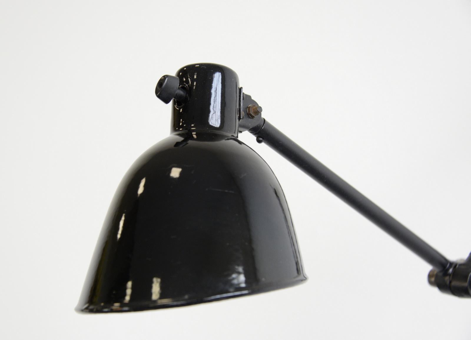 Wall-mounted task lamp by Kandem, circa 1930s

- All prices inc UK shipping
- Vitreous black enamel shade
- On/Off toggle switch on the shade
- Adjustable arms
- Takes E27 fitting bulbs
- Cast iron wall bracket
- Made by Korting & Mathiesen,