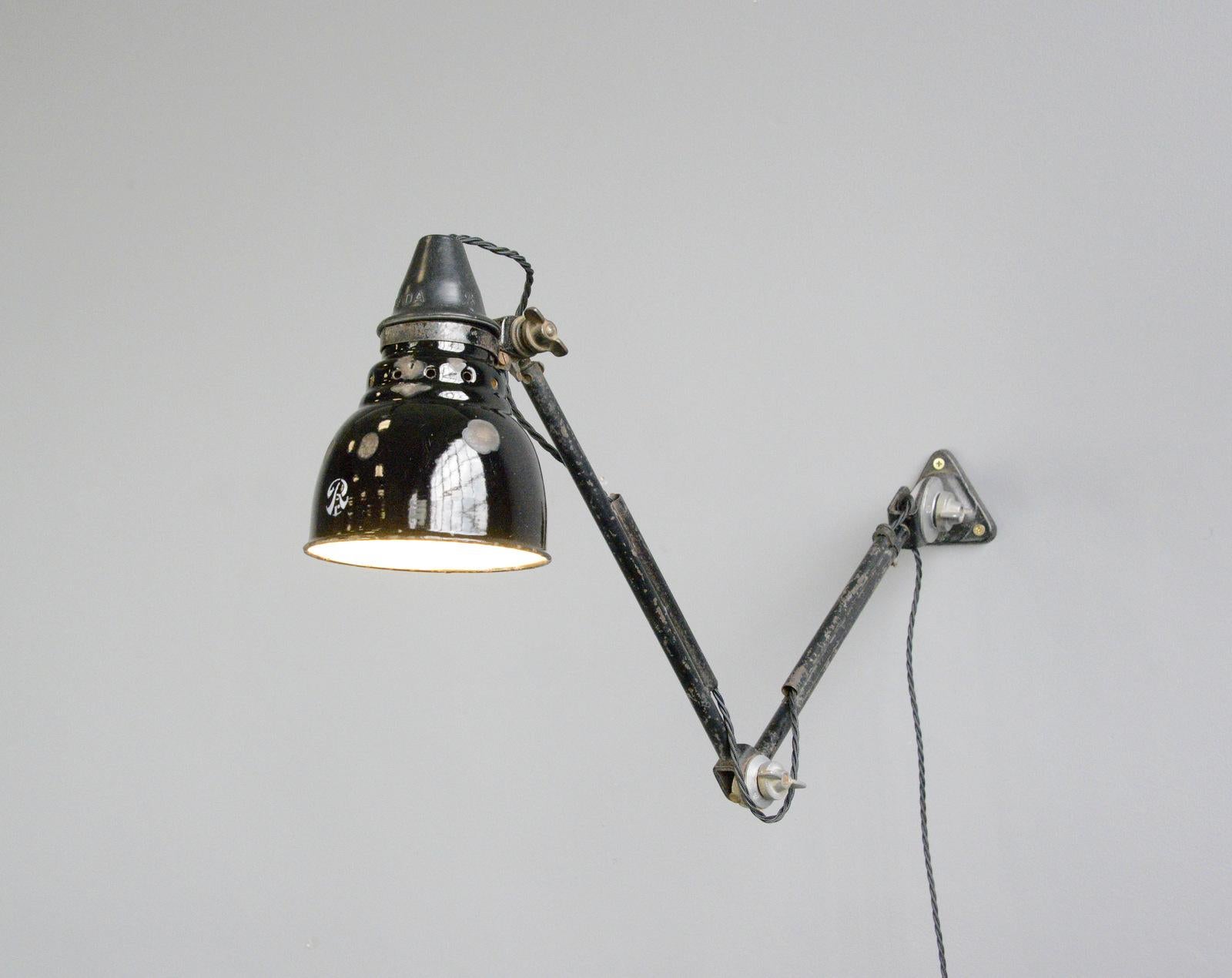 Wall mounted task lamp by Rademacher Circa 1920s

- Vitreous black enamel shade
- Bakelite switch
- Takes E27 fitting bulbs
- Tubular steel articulated arms
- By Ernst Rademacher
- German ~ 1920s
- Shade measures 14cm wide 
- Extends up to