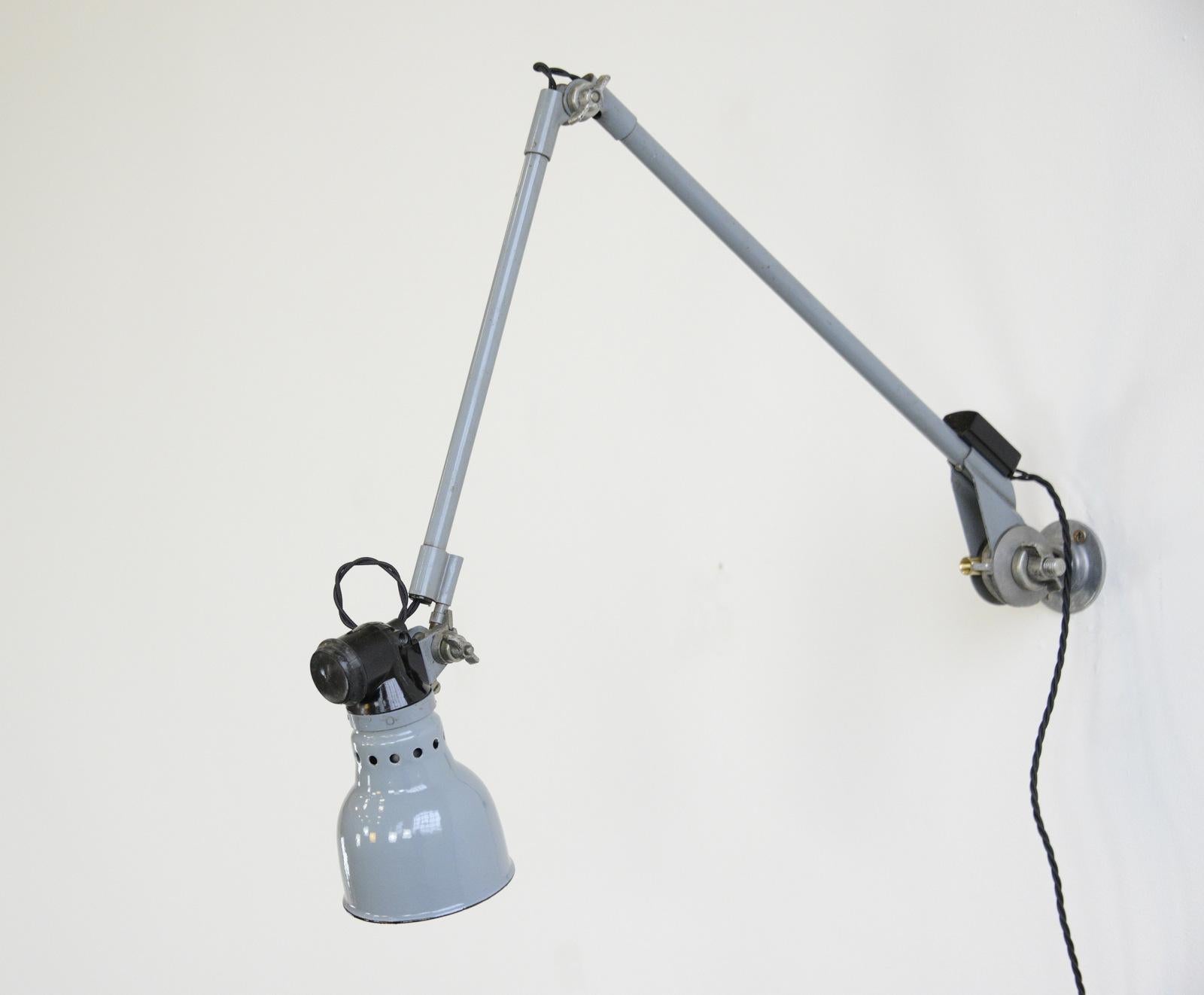 Wall mounted task lamp by Rademacher, circa 1930s

- Vitreous grey enamel shade
- Bakelite switch
- Takes E27 fitting bulbs
- Tubular steel articulated arms
- By Ernst Rademacher
- German, 1930s
- Shade measures 11cm wide 
- Extends up to
