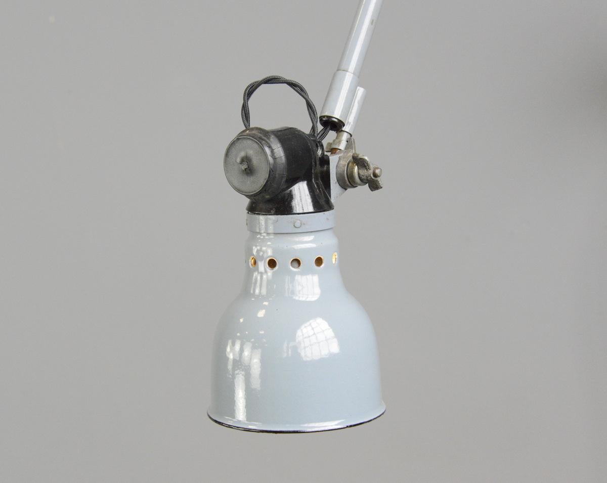 Wall mounted task lamp by Rademacher, circa 1930s

- Vitreous grey enamel shade
- Bakelite switch
- Takes E27 fitting bulbs
- Tubular steel articulated arms
- By Ernst Rademacher
- German, 1930s
- Shade measures 11cm wide 
- Extends up to