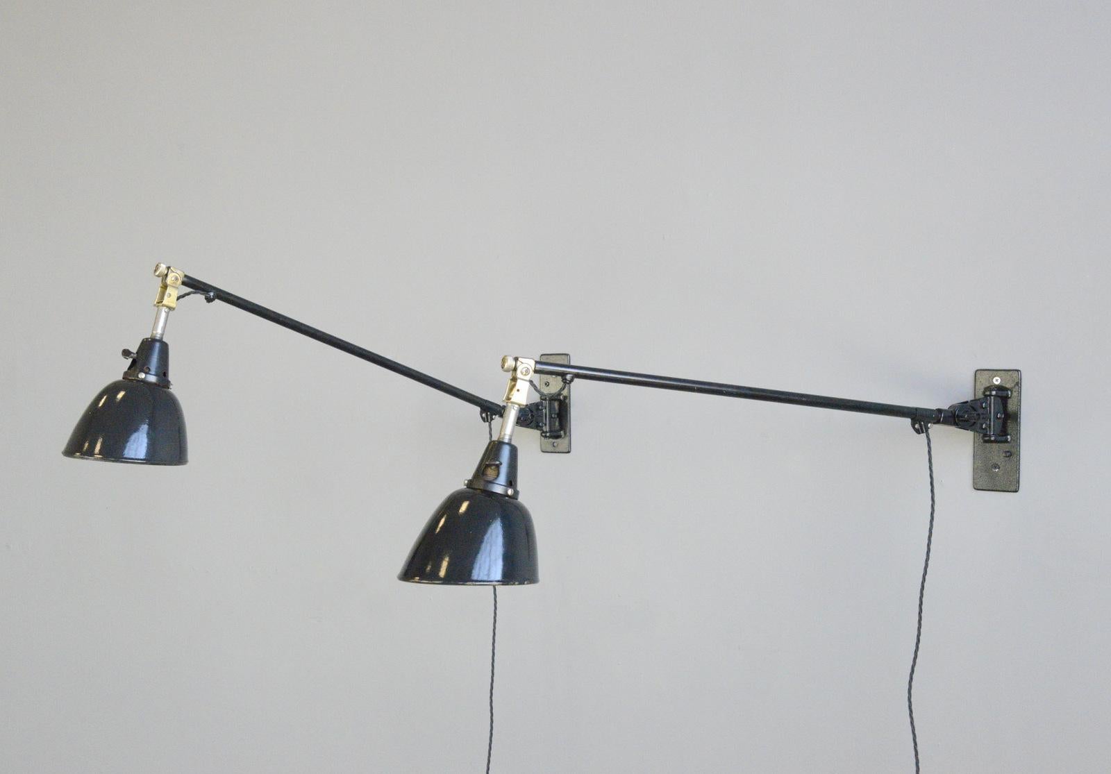 Wall-mounted task lamps by Midgard, circa 1930s

- Price is per lamp
- Black enamel shades
- Articulated steel arms
- On/Off toggle switches on the shades
- Brass detail on the joints
- Takes E27 fitting bulbs
- Designed by Curt Fischer
-