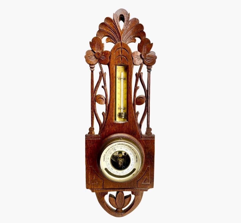 Wall-Mounted Weather Station in Art Nouveau Style Carved Oak By Grand Bazar 1910s  Liege Belgium
High quality mechanism with jeweled movement barometer and thermometer (in centigrade)
Unusual design with high relief C-scrolls and Flowers
 (from
