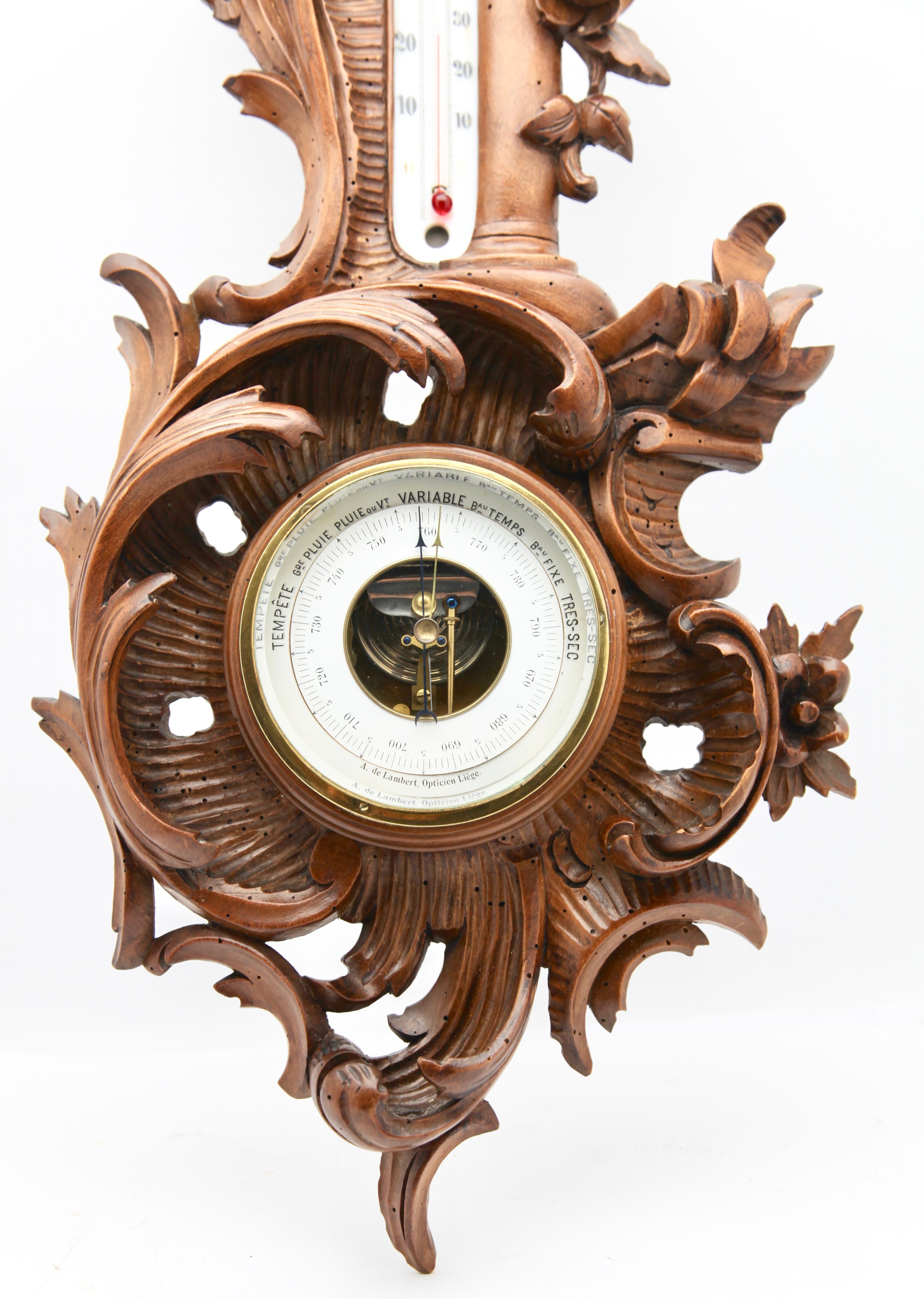 Wall-mounted weather station in carved walnut made in Belgium by A. de Lambert. High quality mechanism with jeweled movement barometer and thermometer (in centigrade)
Unusual design with high relief C-scrolls and flowers in Rococo style (from the
