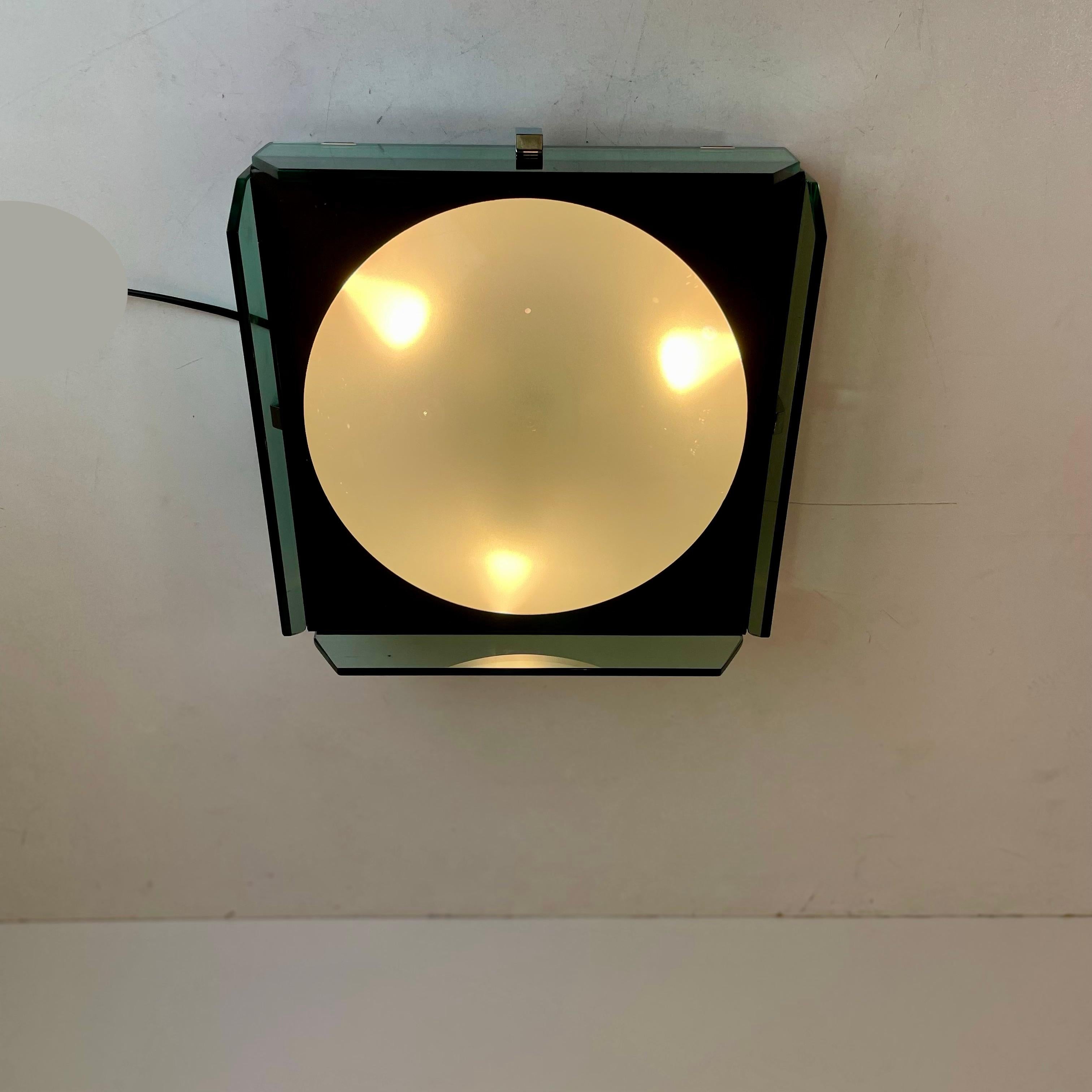 Italian wall and/or ceiling lamp made of a dark taupe enameled metal box with a spherical plexiglass lampshade in the middle and chromed glass on each side. Designed as a bathroom accessory in the 1970’s.
-
Produced by: unknown
Origin: Italy
Design