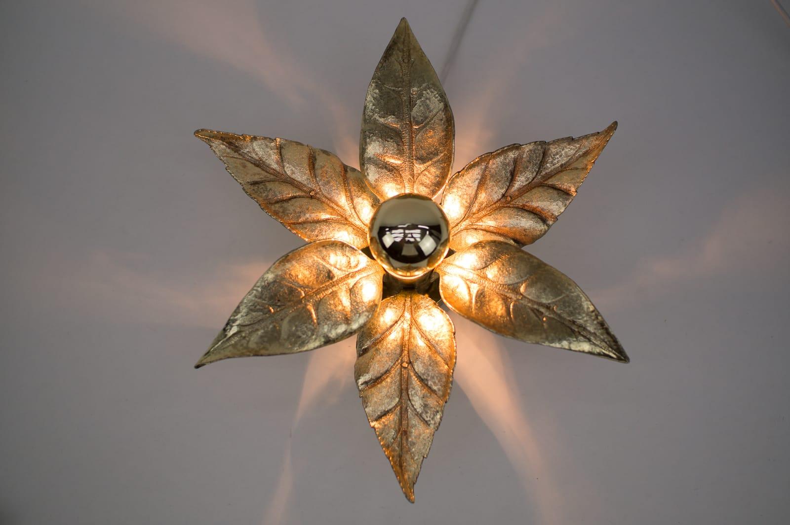 A gold wall sconce or wall light by Belgian designer Willy Daro for lighting manufacturer Massive. It has a wonderful naturalistic shape and is very decorative of the 1970s era.

The double lamp is 75cm long and 18cm depth, with bulb 22cm.

We have