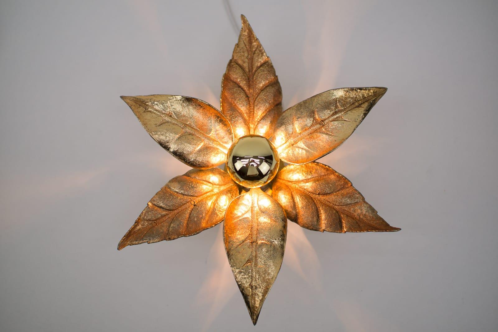 A gold wall sconce or wall light by Belgian designer Willy Daro for lighting manufacturer Massive. It has a wonderful naturalistic shape and is very decorative of the 1970s era.

The double lamp is 75cm long and 18cm depth, with bulb 22cm.

We have