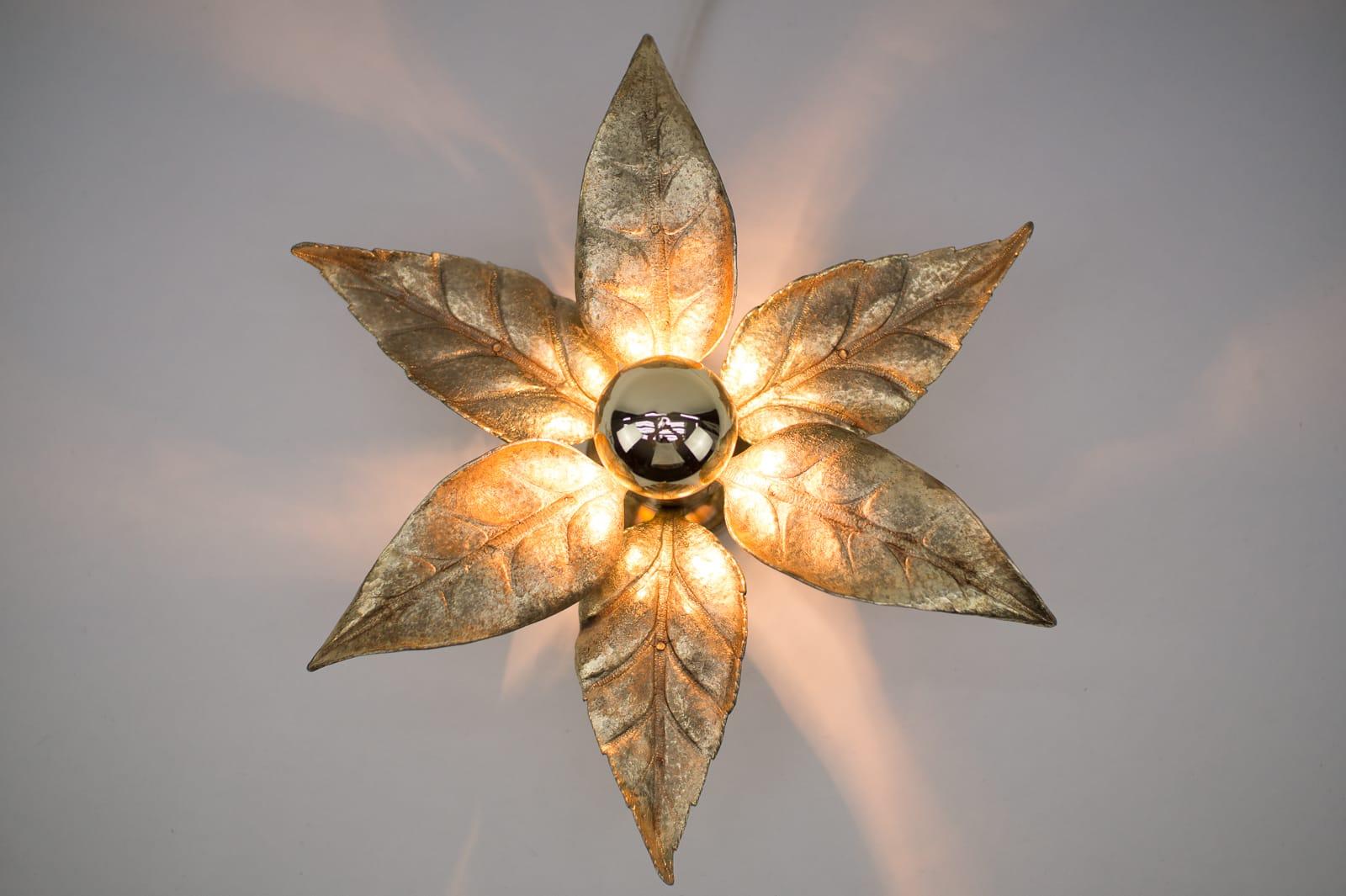 A gold wall sconce or wall light by Belgian designer Willy Daro for lighting manufacturer Massive. It has a wonderful naturalistic shape and is very decorative of the 1970s era.

The double lamp is 75cm long and 18cm depth, with bulb 22cm.

We have