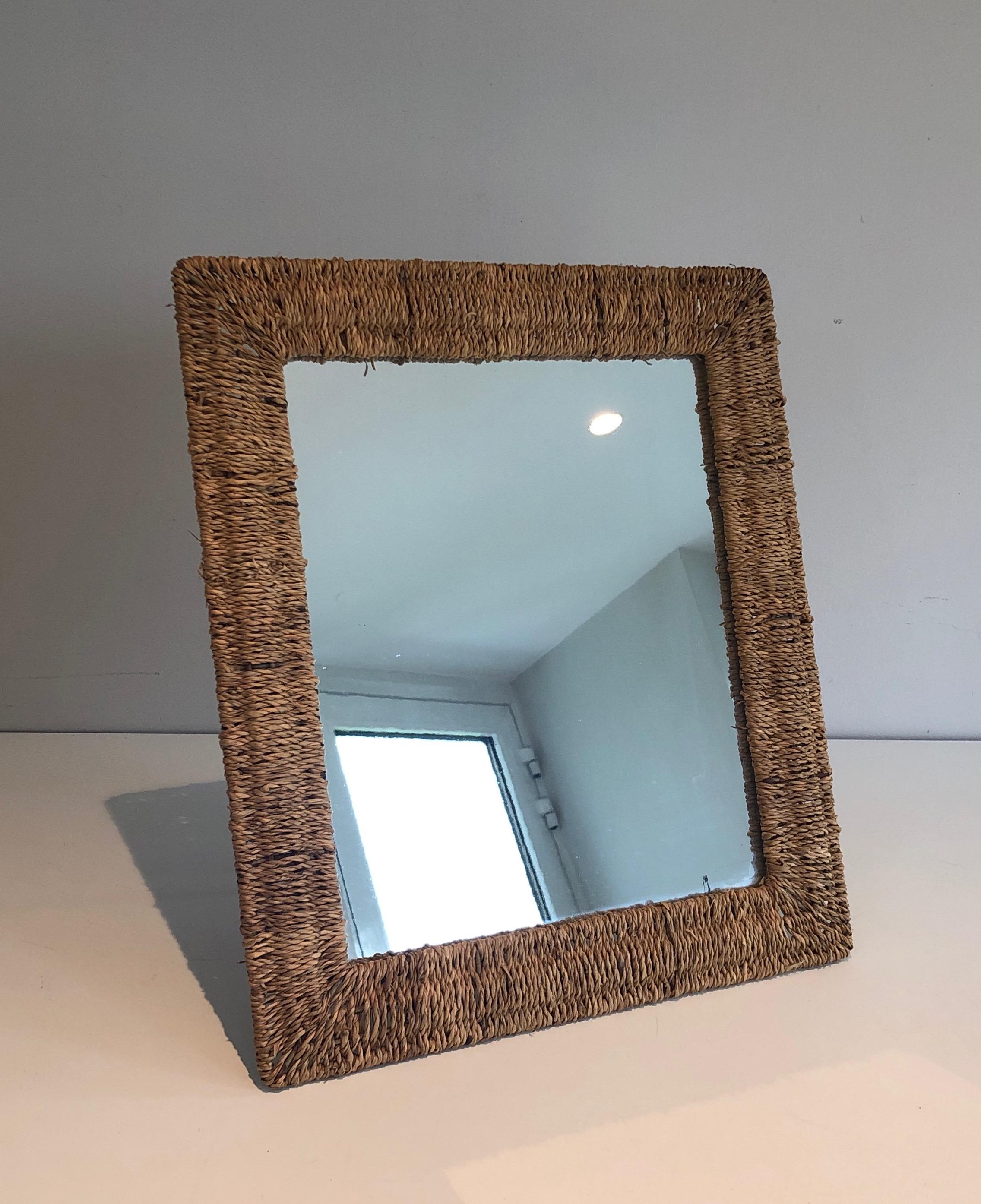 This wall or standing mirror is made of rope. This is a French work in the style of Audoux Minet. circa 1970