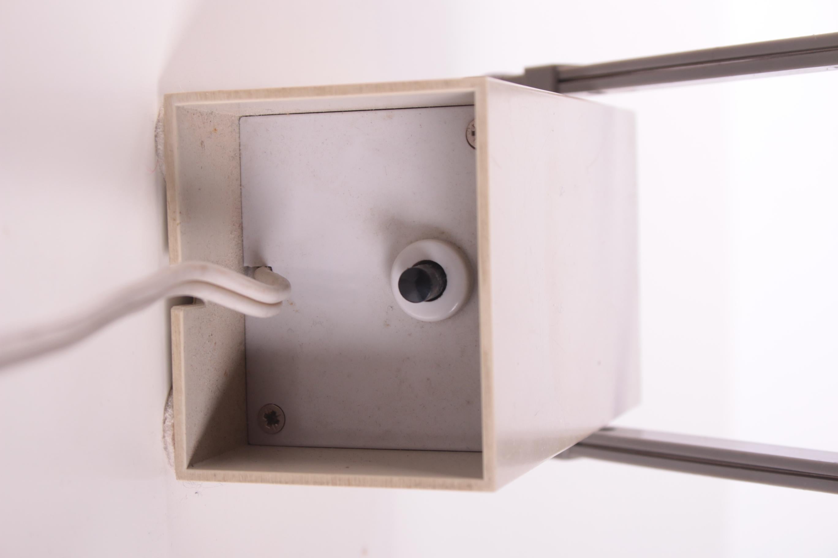 Wall or table lamp Lampetit designed by Bent Gantzel-Boysen (1930-2008) for Louis Poulsen in 1966. 
A small compact lamp with rectangular shapes that was ahead of its time. 
This wall or table lamp is often attributed to Verner Panton but was
