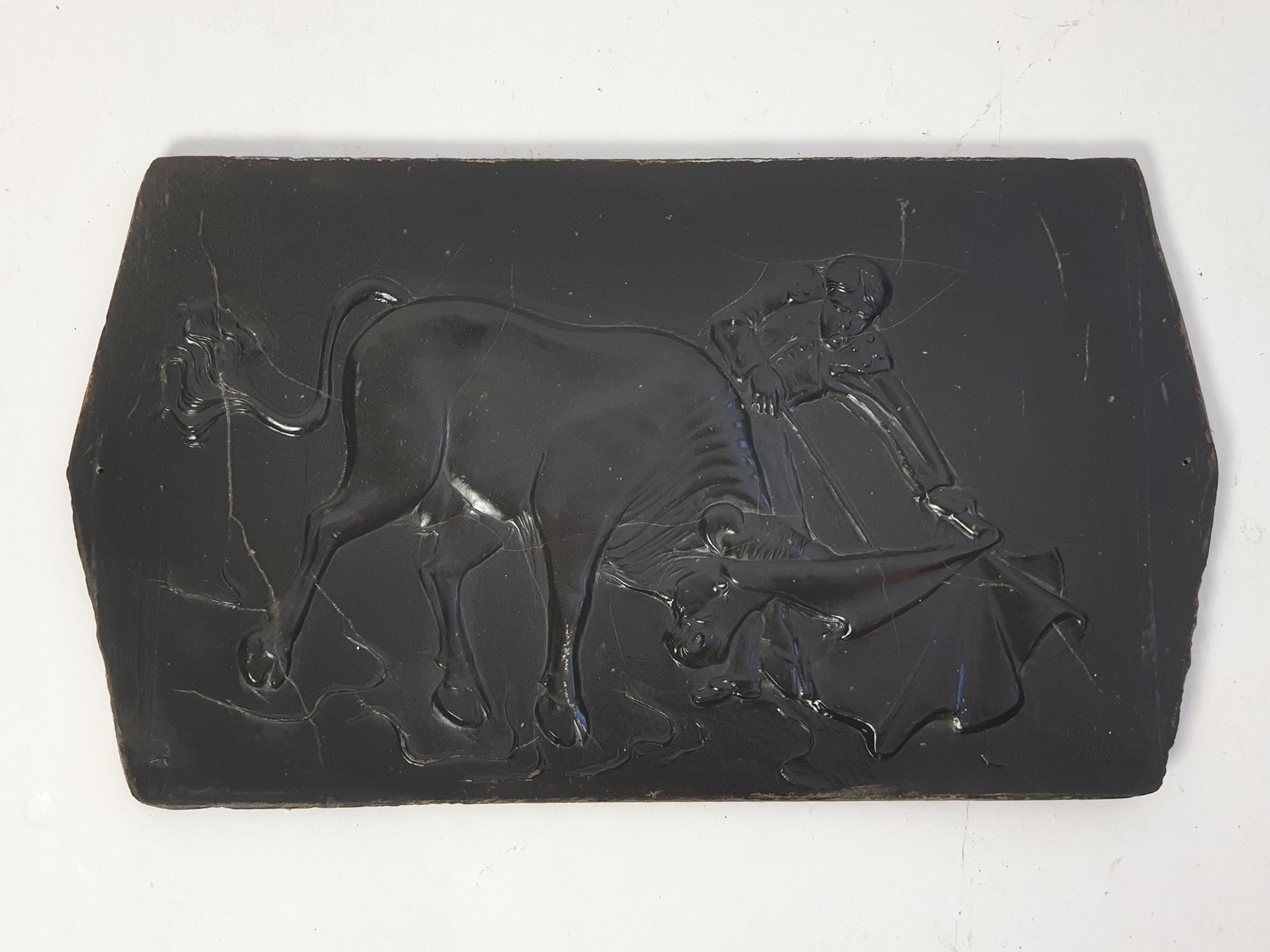 Eine Wandtafel aus Schiefer, auf der ein Stierkämpfer und ein Stier abgebildet sind. Wurde irgendwann in den 1970er Jahren hergestellt. In gutem Zustand mit einigen Gebrauchsspuren.  Höchstwahrscheinlich italienische Produktion. 