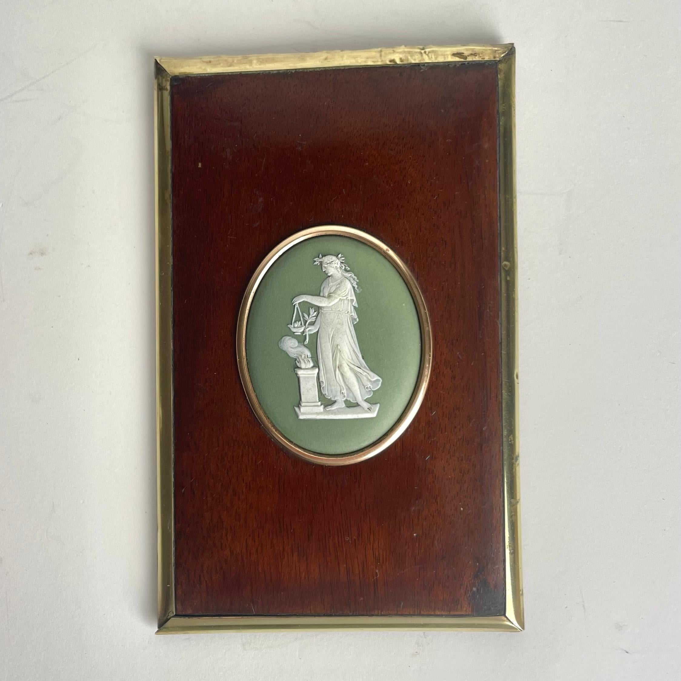 Elegante placa de pared con medallón Wedgewood de decoración clásica sobre un marco de caoba (Swietenia mahogoni) con adornos de latón. Probablemente Inglaterra, mediados del siglo XIX.


Desgaste propio de la edad y el uso 