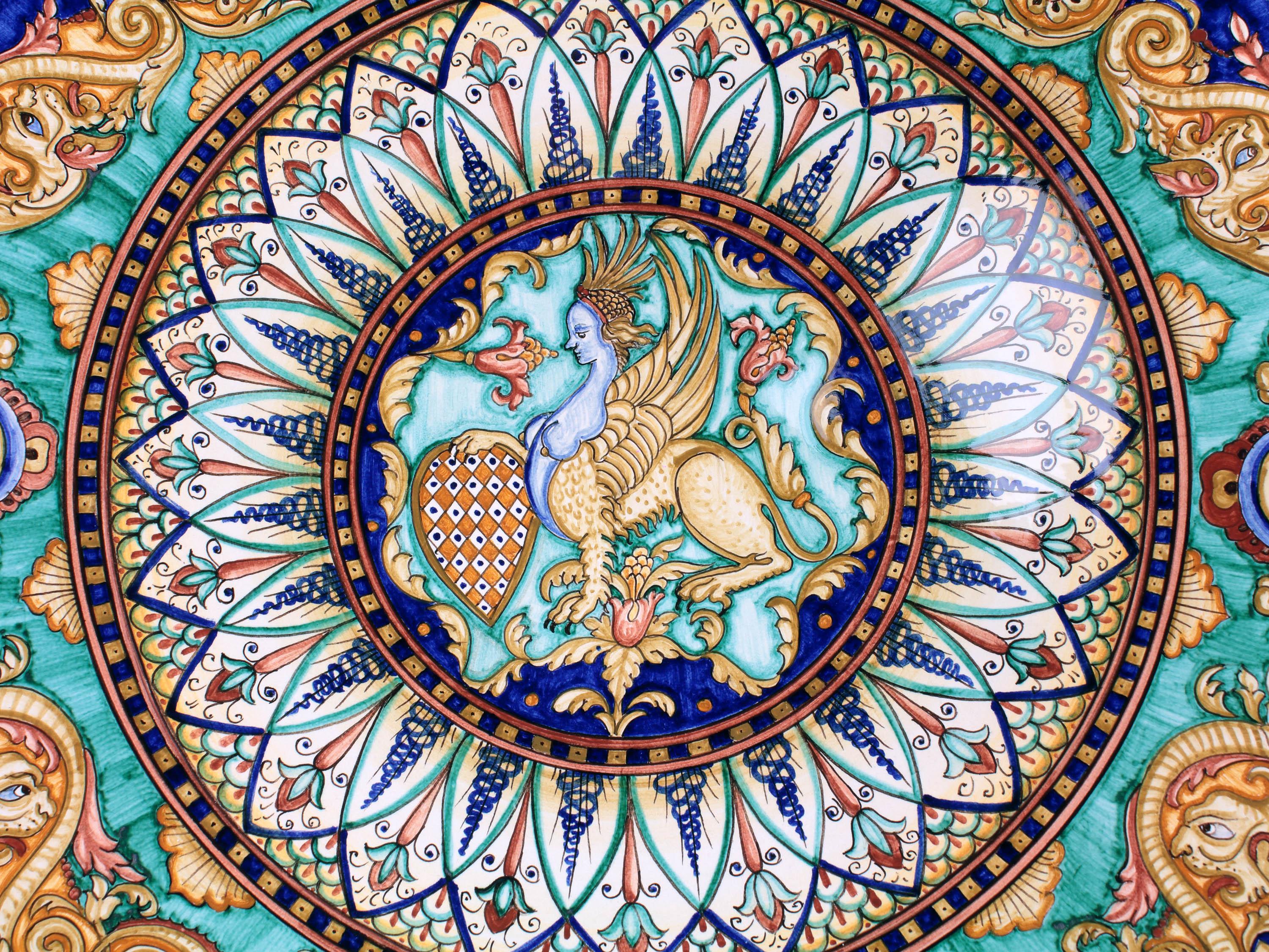 Large plate Made and hand painted in Italy according to the original Renaissance painting technique. The plate is decorated in polychrome painted majolica, according to a rich grotesque motif inspired by the tradition of the fifteenth century. In