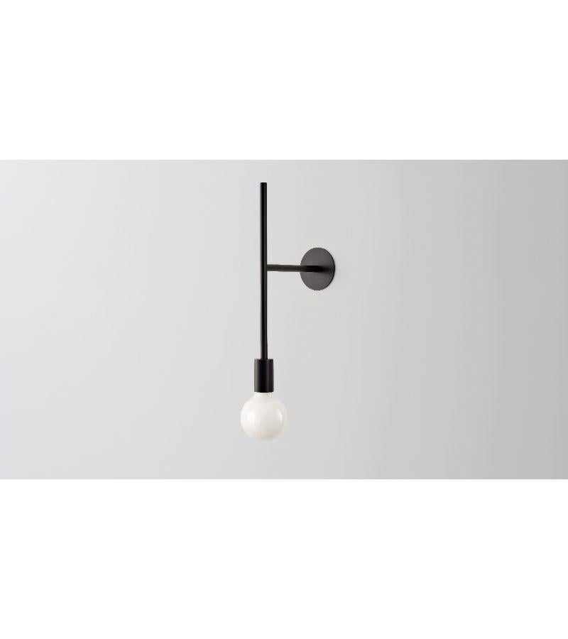 Wall powered step light by Volker Haug
Dimensions: D 24.8 x W 9.5 x H 55.5 cm 
Material: Brass. 
Finishes: Polished, aged, brushed, bronzed, blackened, or plated
Lamp: Opal G95 LED (E26/E27 110 - 240V, 12V version available)
Weight: approx 1.2