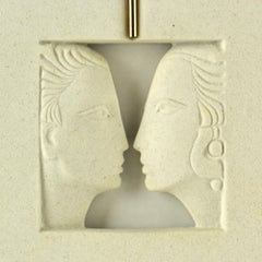 Wandrelief Silhouette Gesichter in Stein gehauen