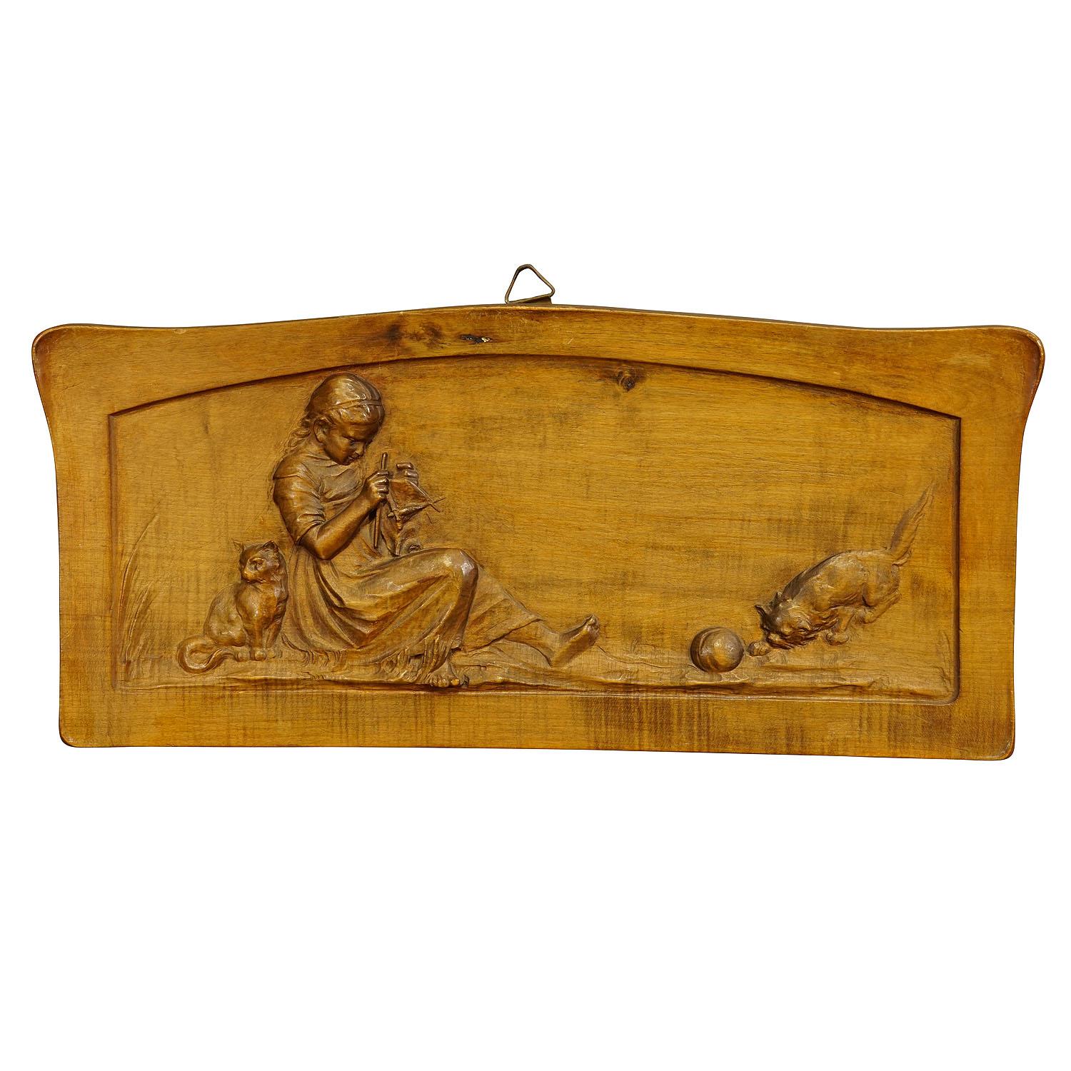 Wall Relief wood carving with farmer girl and kitten ca. 1900

A wooden carved wall relief depicting a knitting farmer girl in folksy costume with her kitten. Finely carved in lindenwood in Germany circa 1900. A very nice log cabin wall