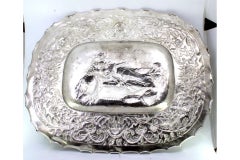 Wall salver in relief silver with an elliptical Biblical scene and wavy edge