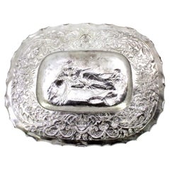 Wall salver in relief silver with an elliptical Biblical scene and wavy edge