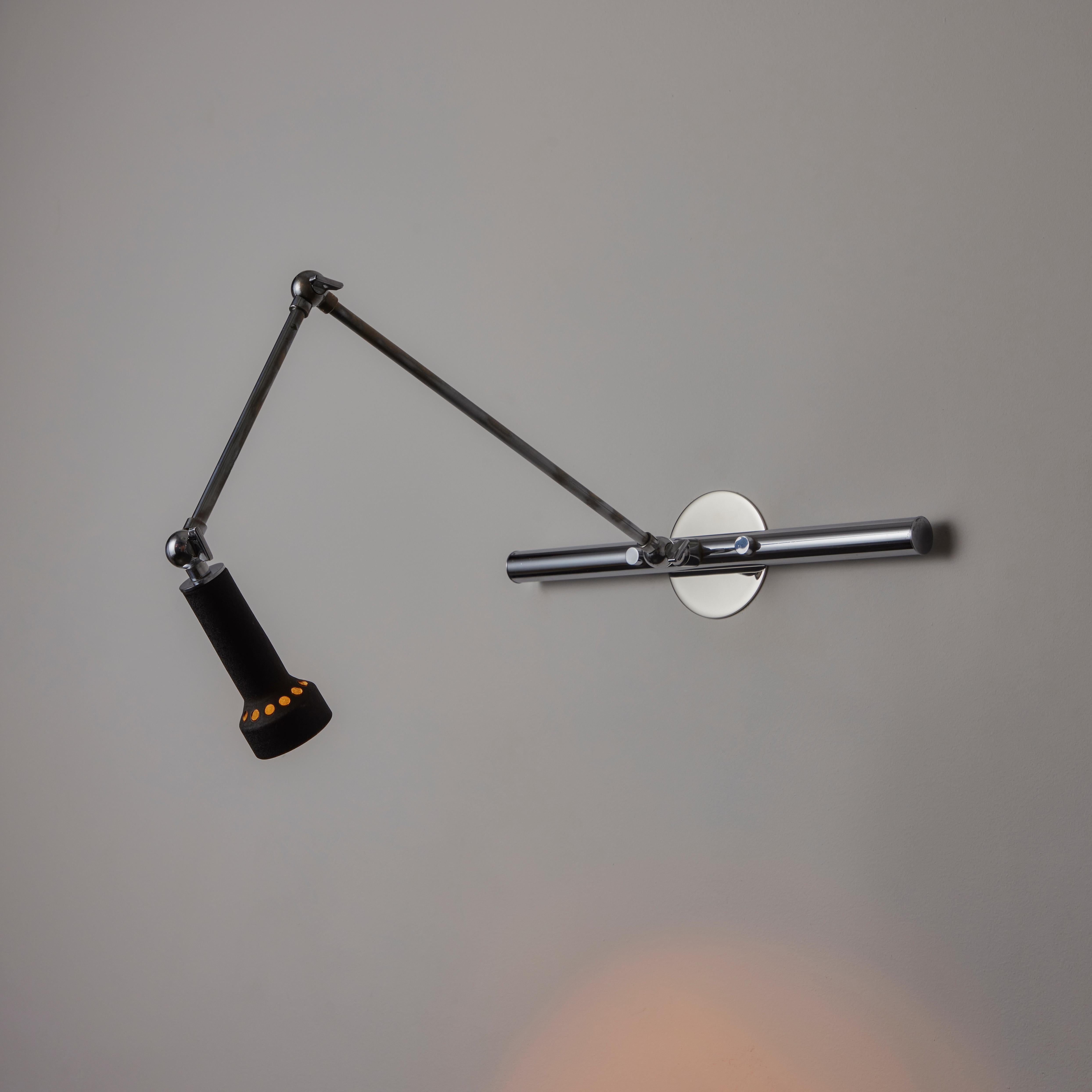 Wall Sconce by Angelo Lelii for Arredoluce. Designed and manufactured in Italy, circa the 1950s. A picture light or wall sconce consisting of a multiple articulating chrome armature and enameled black shade. The arms can be manipulated by adjstign