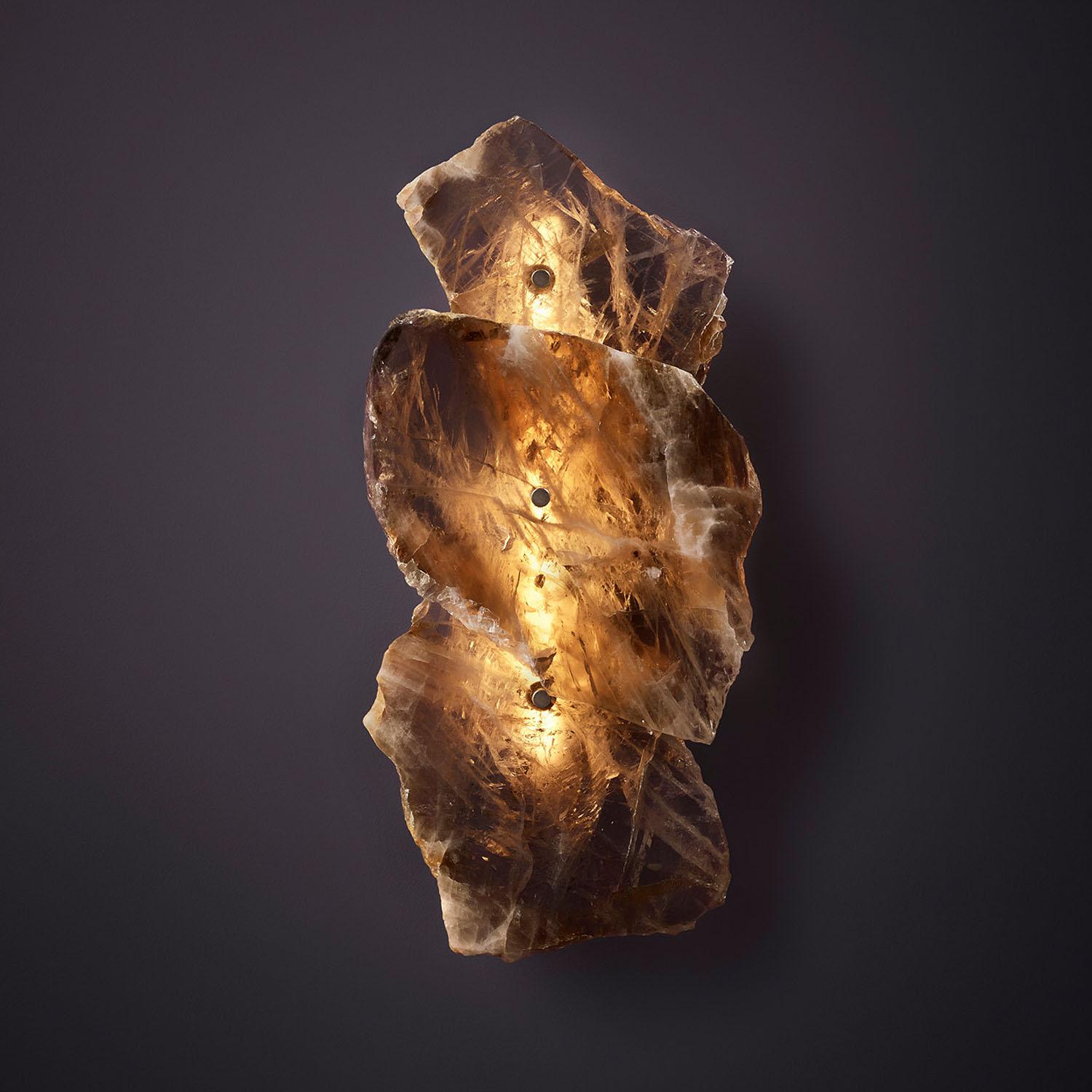Contemporary wall sconce in Quartz with brass base - Petra I Triple by Christopher Boots

PETRA (from the Greek word ??t?a, meaning stone) celebrates the complexity and subtleties in the material composition in Quartz that PETRA is made