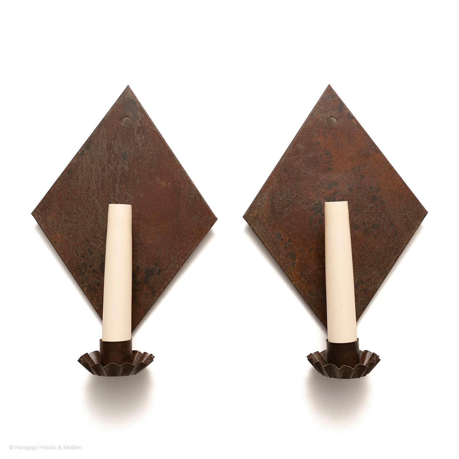 Surviving pieces of vernacular lighting are extremely rare and it is hard to source convincing re-creations. These are copies of a period sconce from the Wallace Nutting Collection and have a plausible antiqued patina.

Pair of diamond shaped,