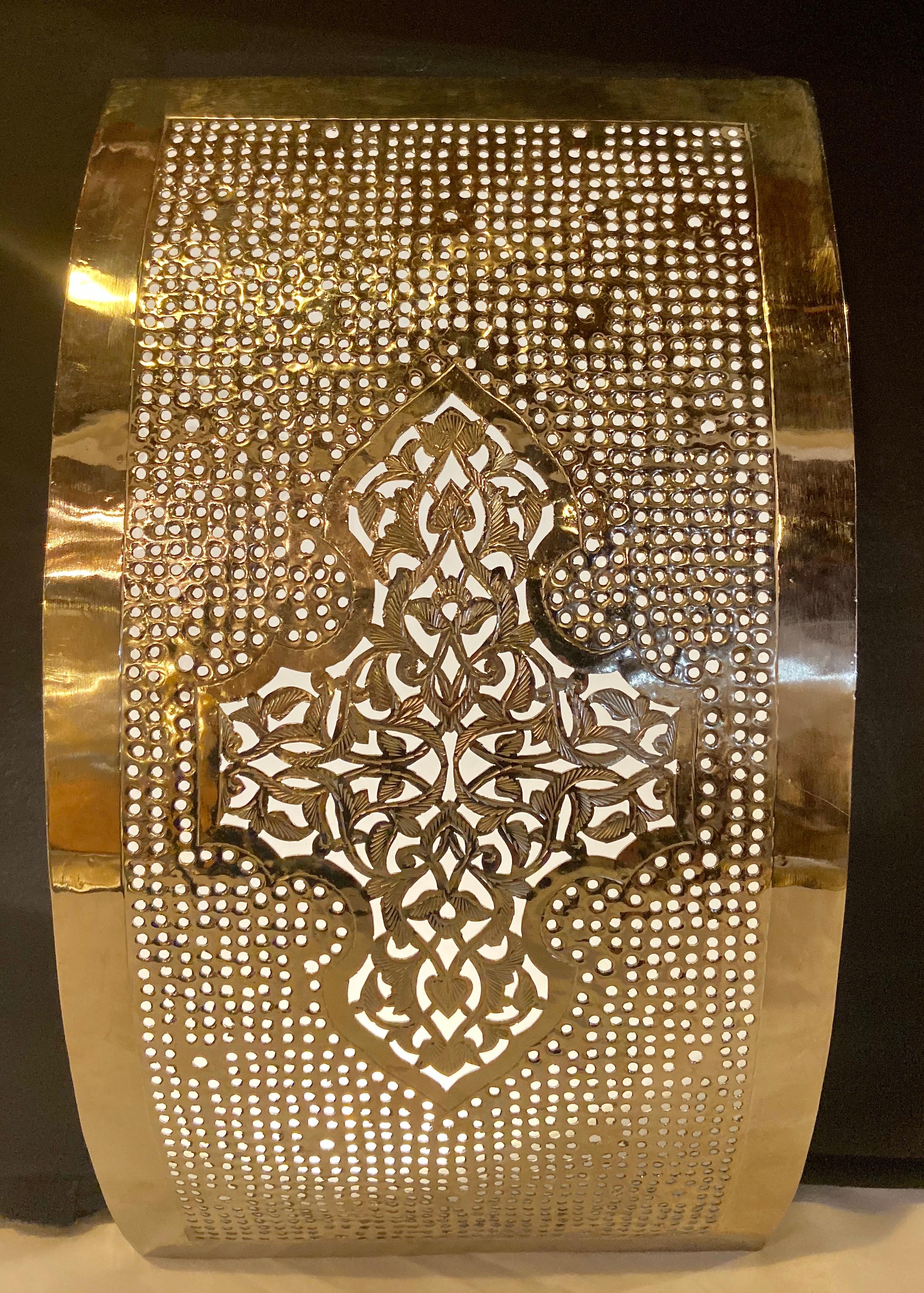 The pair of handmade Moroccan design white brass wall lanterns or sconces features exquisite filigree work that will elevate the ambiance of any room.This wall-mounted sconce emits a soft, filtered light. The wall lanterns or scones are not wired as