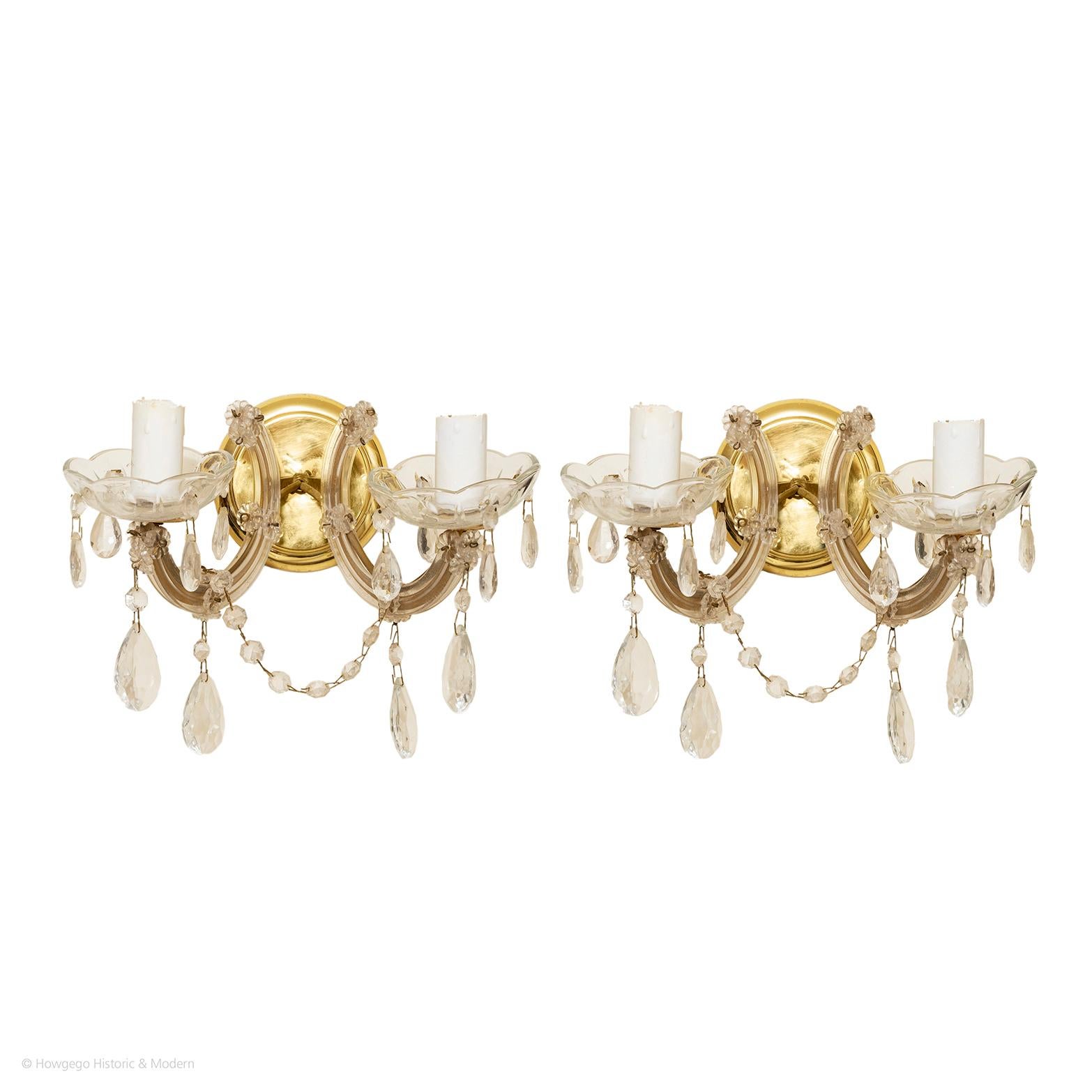 SMALL PAIR OF EDWARDIAN, TWO-ARM, GILT-BRASS & GLASS WALL SCONCES IN THE ROCOCO STYLE

- The lightness, elegance, and an exuberant use of curving and floral ornamentation are characteristic features of the Rococo period
- The glass enhances the