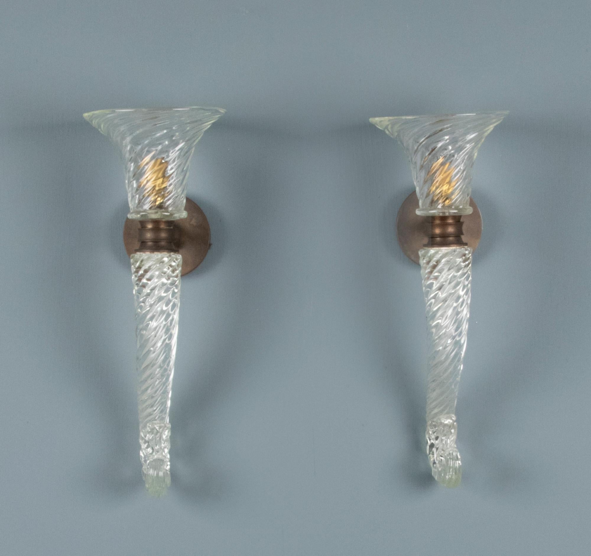 A beautiful pair of wall lamps from the famous Murano maker Seguso. The lamps are made of Murano glass with copper mounts. Beautifully turned glassware, both lamps are hand signed in the chalice. These lamps date from circa 1940. Great condition.