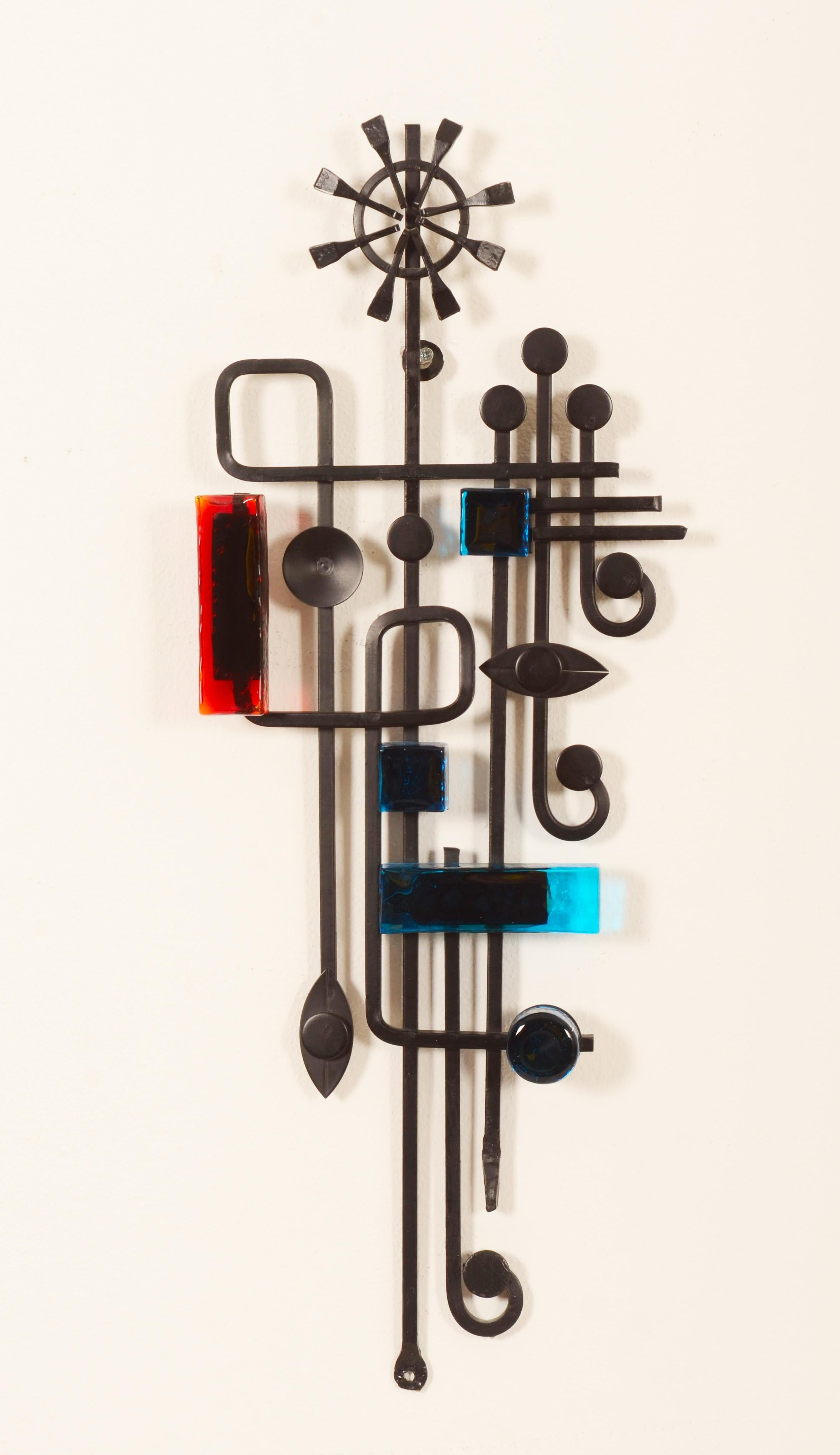 Ebonised metal abstract art work with blue and red glass elements. Created in the 1960s by Svend Aage Holm Sorensen.