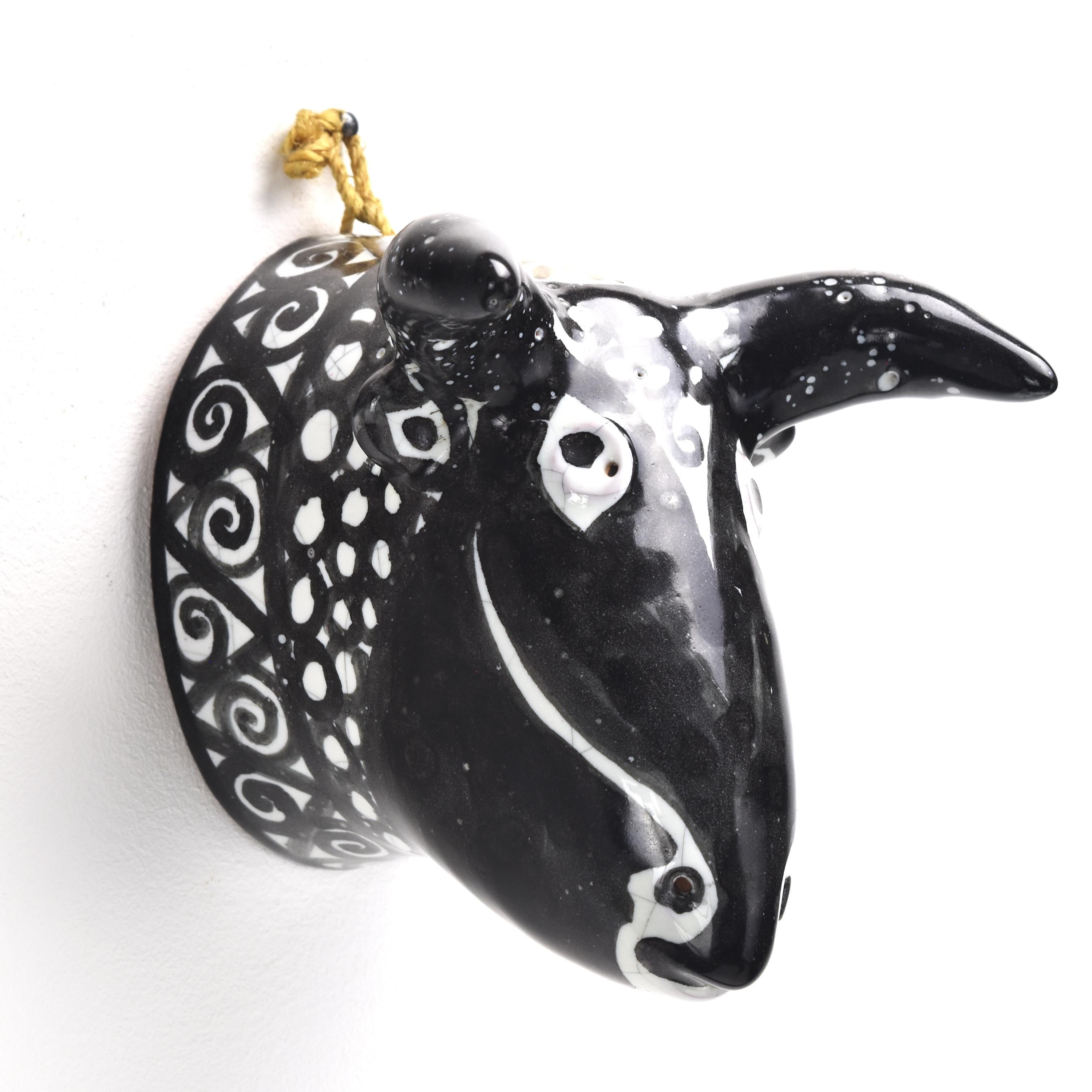 This hand-painted wall-hanging bull head, inspired by Picasso's figurative style and likely made by Robert Picault is a striking and artistic piece of decor. Combining the iconic imagery of the bull with Picasso's unique artistic language, this