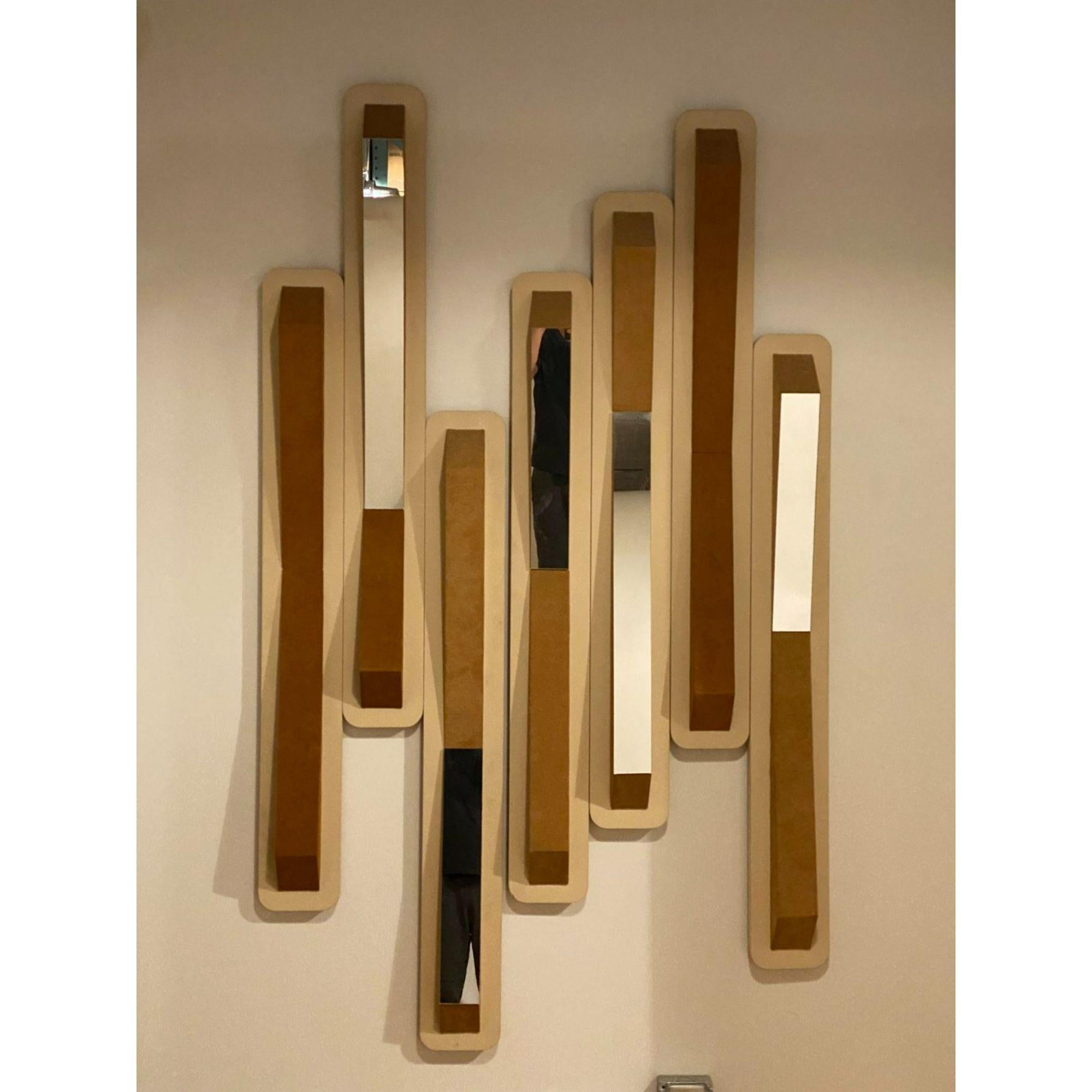 Massive vintage modern wall sculpture by Chicago artist, Steven L. Winer, signed and dated, 1980. This two piece wall hung sculpture is crafted from carved and painted wood with recessed mirror and suede upholstered panels. Although this sculpture