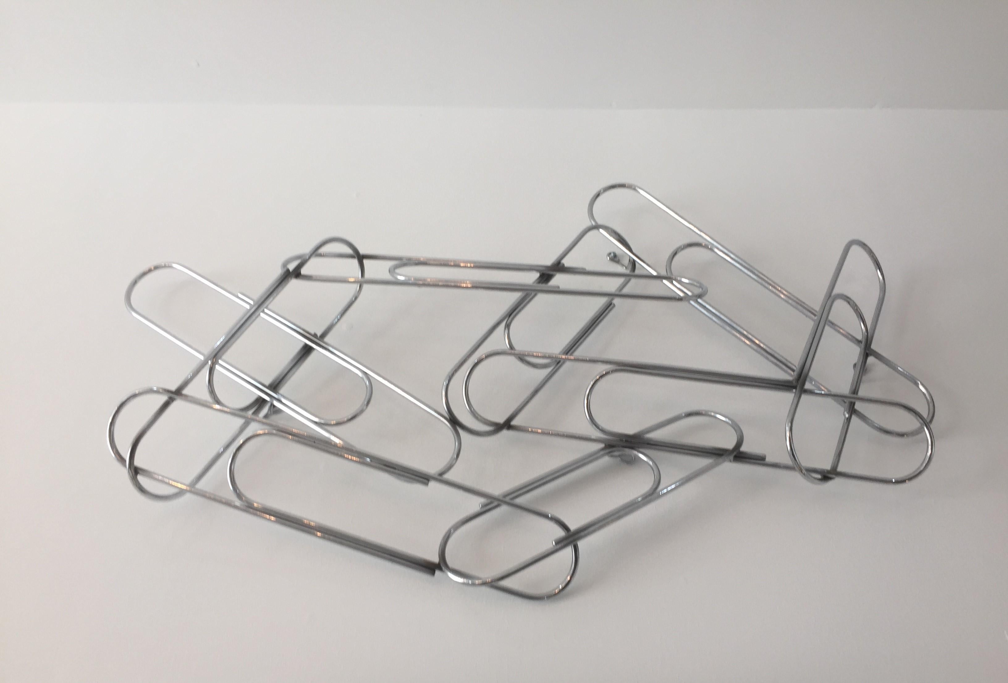 This stylish large scale version of a cluster of paper clips was created in the 1970s by the iconic design team of Curtis Jere and was sold by Artisan House of Los Angeles, CA.

  