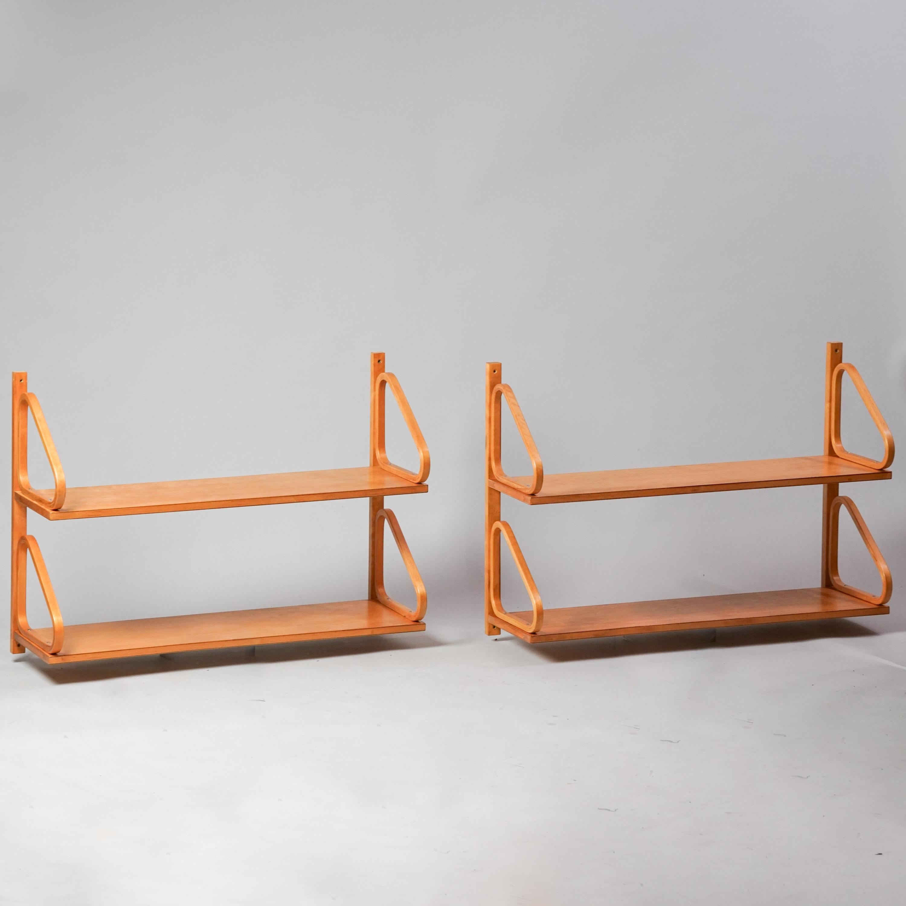 Set of two wall shelves model 112B-2 designed by Alvar Aalto, manufactured by Oy Huonekalu- ja Rakennustyötehdas Ab, 1930s. Birch. Good vintage condition, beautiful patina consistent with age and use. The shelves are sold as a set. Iconic well-known