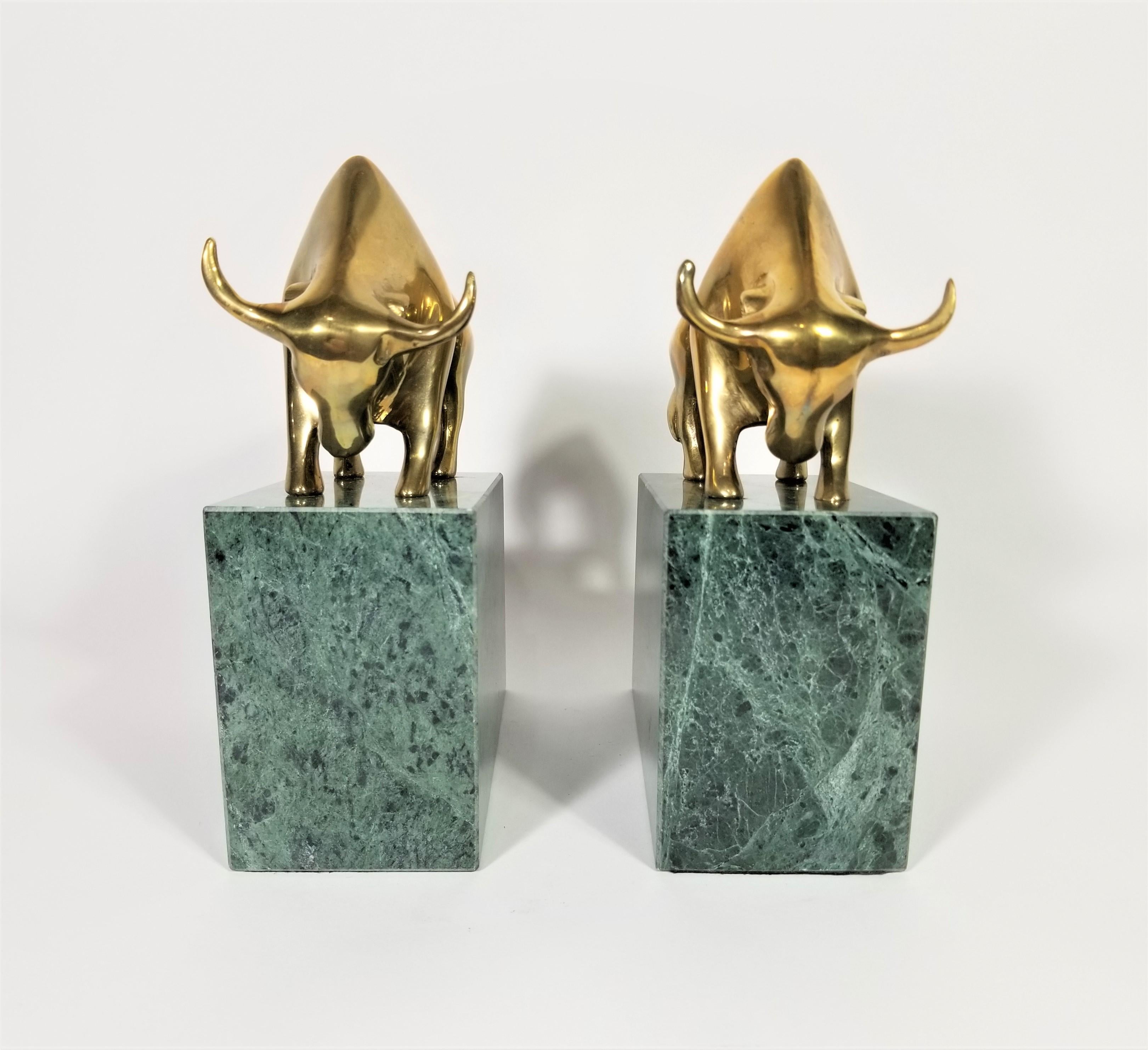 Pair of 1980s Wall Street Bookends. Solid Brass Bulls supported by Solid Green Marble Base. Heavy Substantial weight. Excellent Condition. 