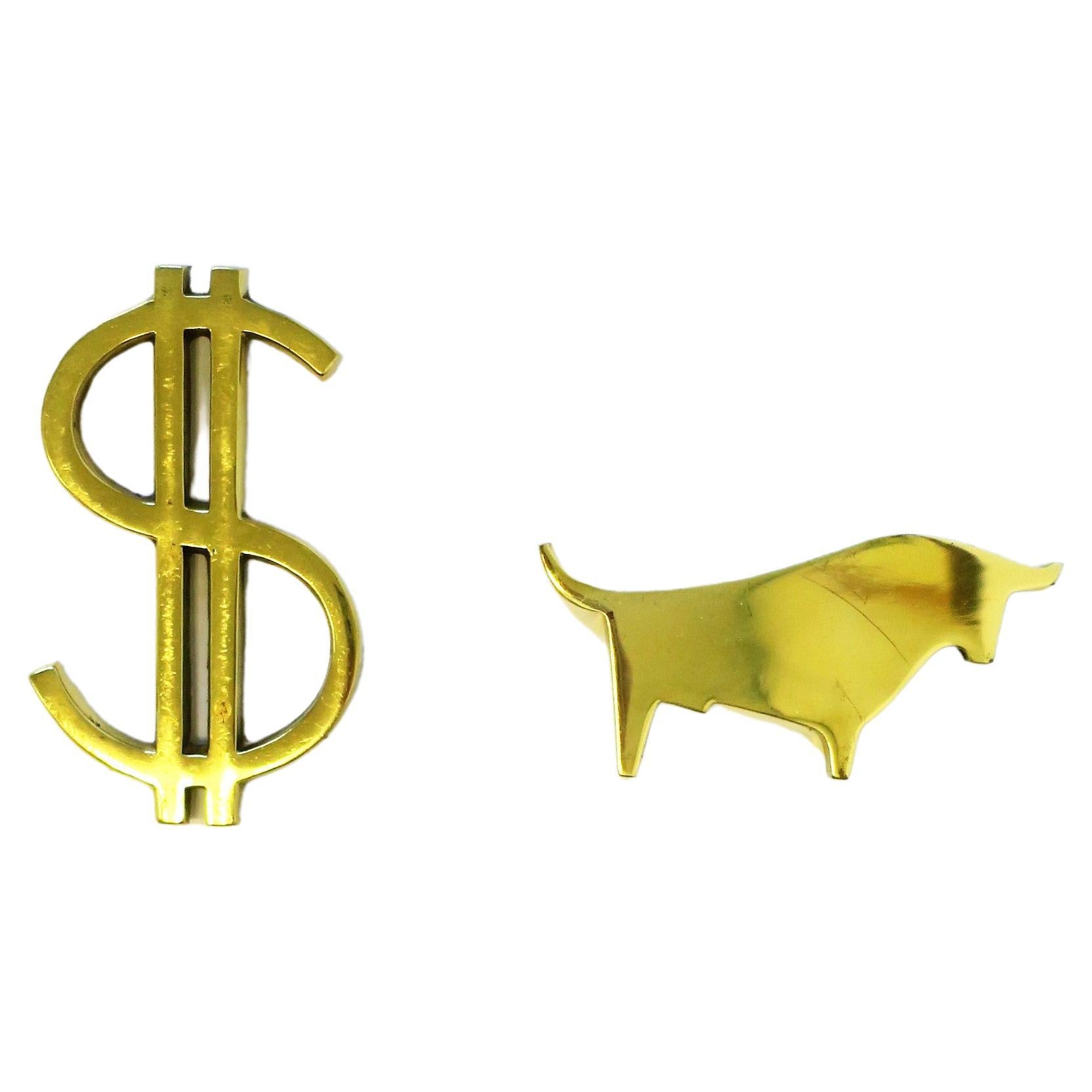A set of Wall Street brass paperweights or decorative objects; a brass dollar sign and bull, circa mid to late-20th century. Great desk accessories. 

Dimensions: 
Dollar sign: 2.82