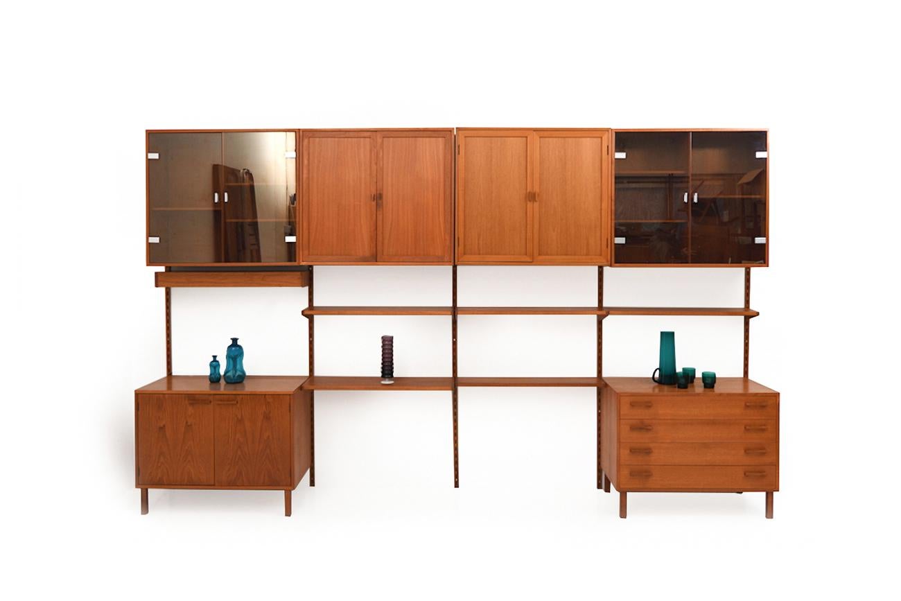 Kai Kristiansen wall / shelf system in teak. Manufactured by FM Feldballe Denmark in 1960s. As usual very good quality with equally beautiful patina.
Incl. the set:
- 5 shelves
- 1 lamp
- 5 cabinets (two with glass doors)
- 1 chest of