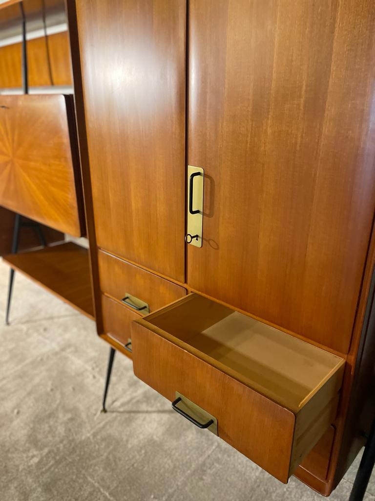 Large teak, black painted metal and brass wall unit by Silvio Cavatorta, with storage areas, drawers, shelves and a bar. Measures: W 303 cm, D 47.5 cm, H 165.5, 180.5 cm.
Perfect condition.
For an interior design, space age, seventies, pop, ... In