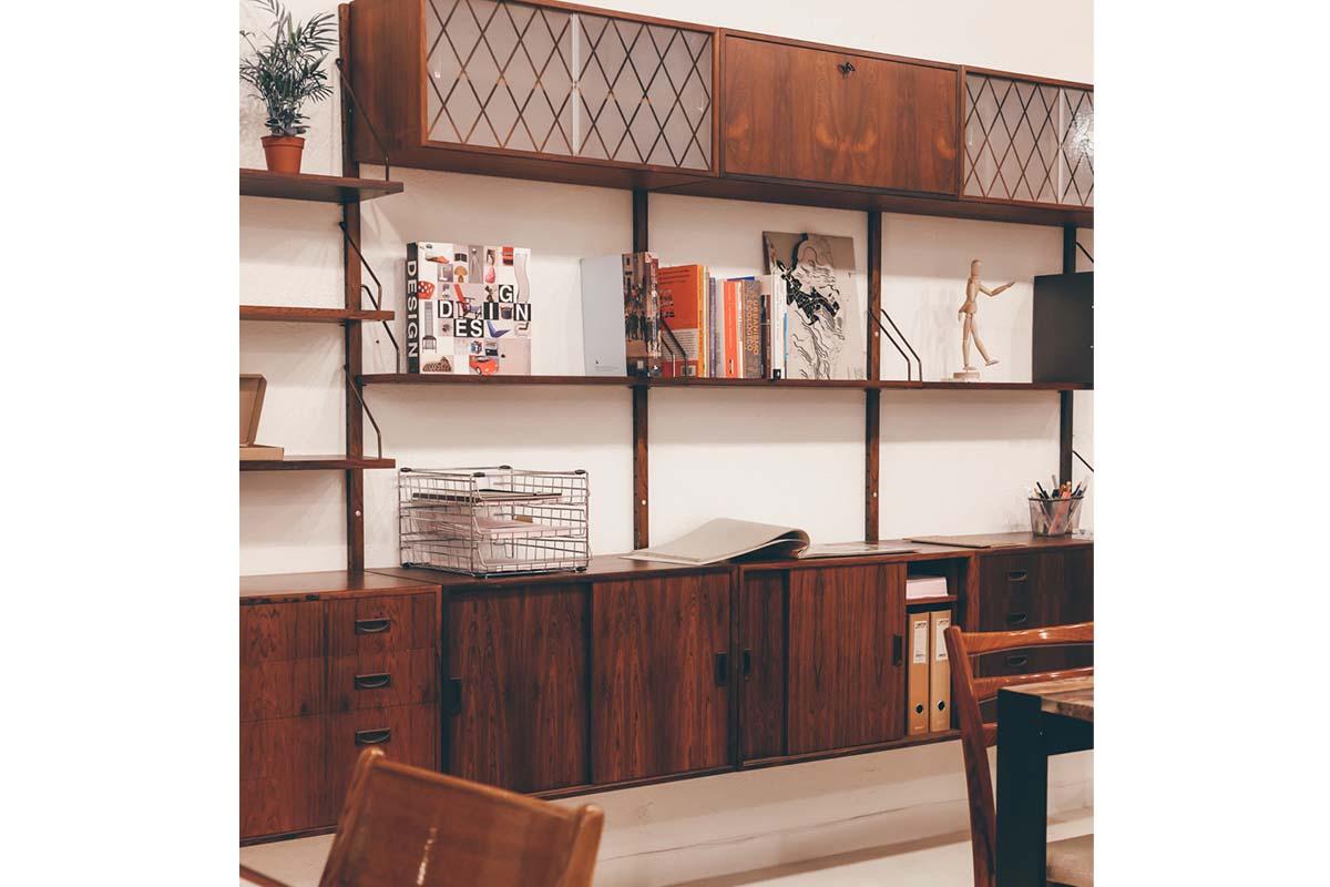 Danish wall unit/shelving system in style of cadovius with five cabinet, a desk, nine shelves and two cabinets with glass door, from the 60s rosewood. This set have brass hardware and wooden rails.