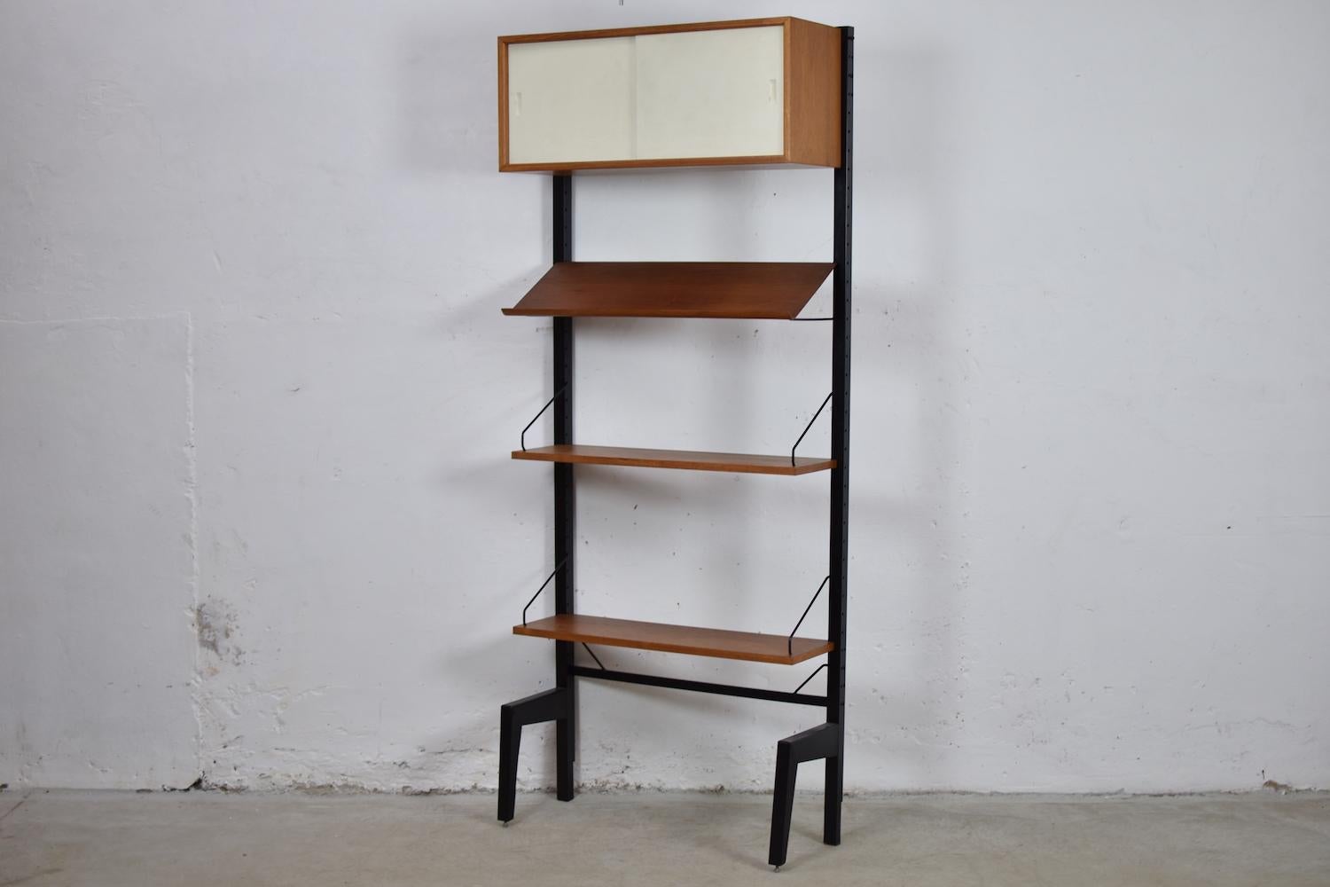 Wall unit designed by Poul Cadovius for royal systems, Denmark, 1950s. This is a flexible and expandable wall unit system so it can be arranged in multiple configurations. The shelves or case piece can be installed anywhere up and down the