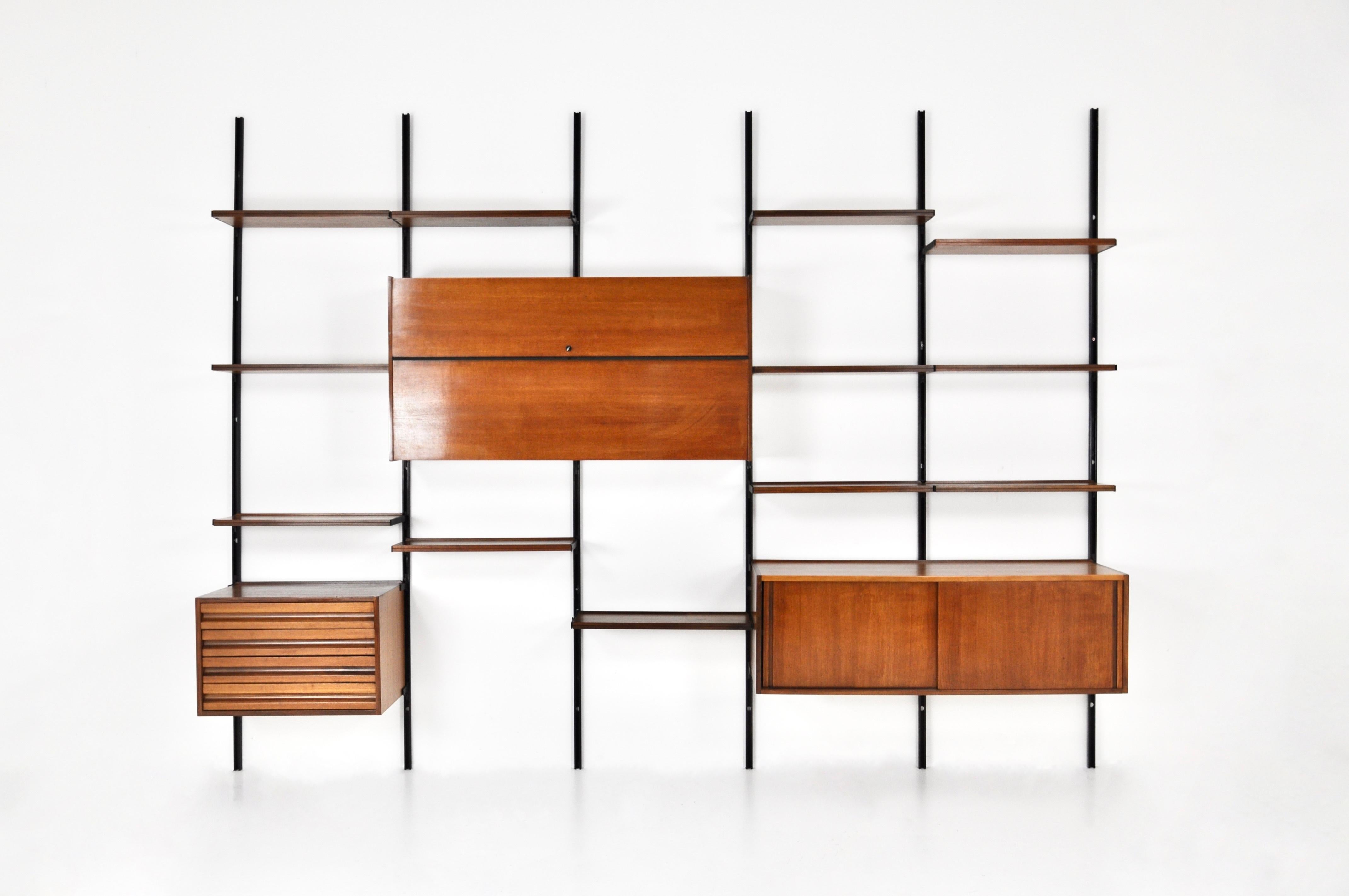 Modular wall unit in wood and metal with 12 shelves, 1 box with 4 drawers, 1 large box with double door and key to close and 1 box with 2 sliding doors containing a shelf. Model E22 designed by Osvaldo Borsani. Wear due to time and age