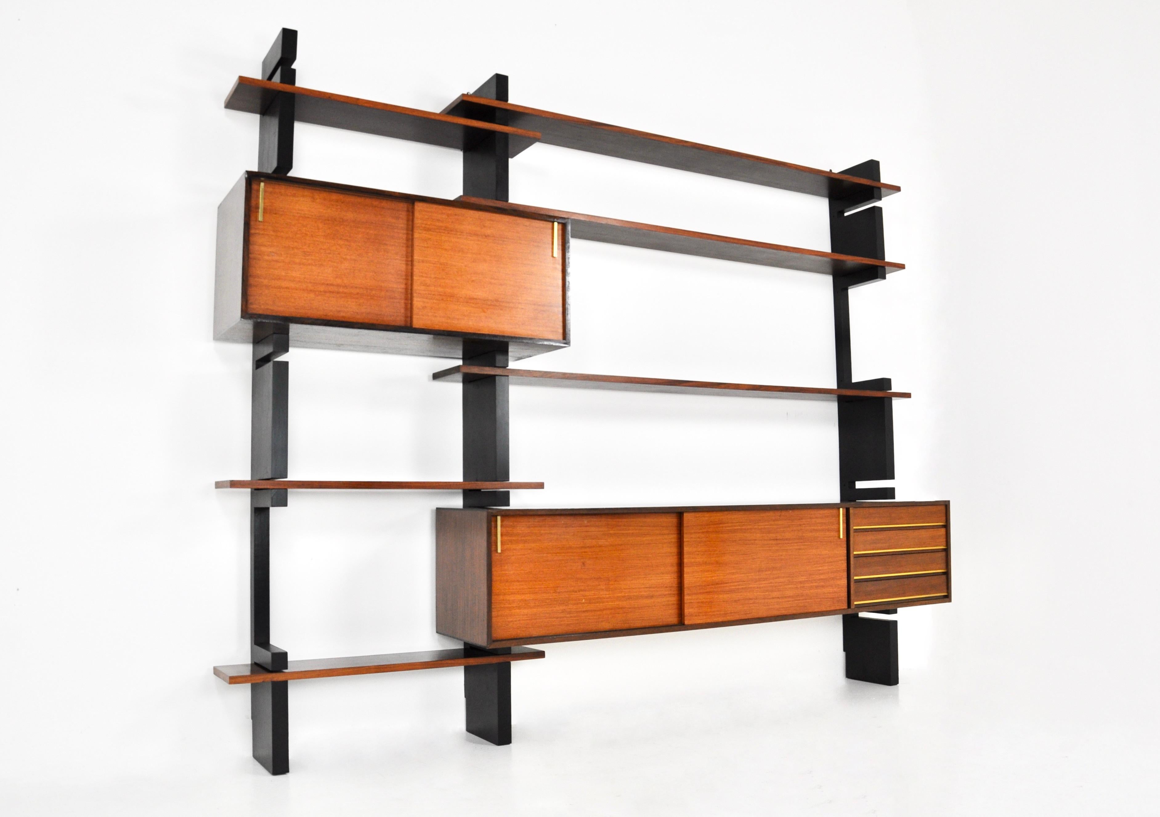 Wooden wall unit in brass, fully modular, consisting of 3 black uprights, 6 boards, a large pedestal with 4 drawers and two sliding doors and a small pedestal with 2 sliding doors. Wear  due to time and age.
For shipping, request us for receive the