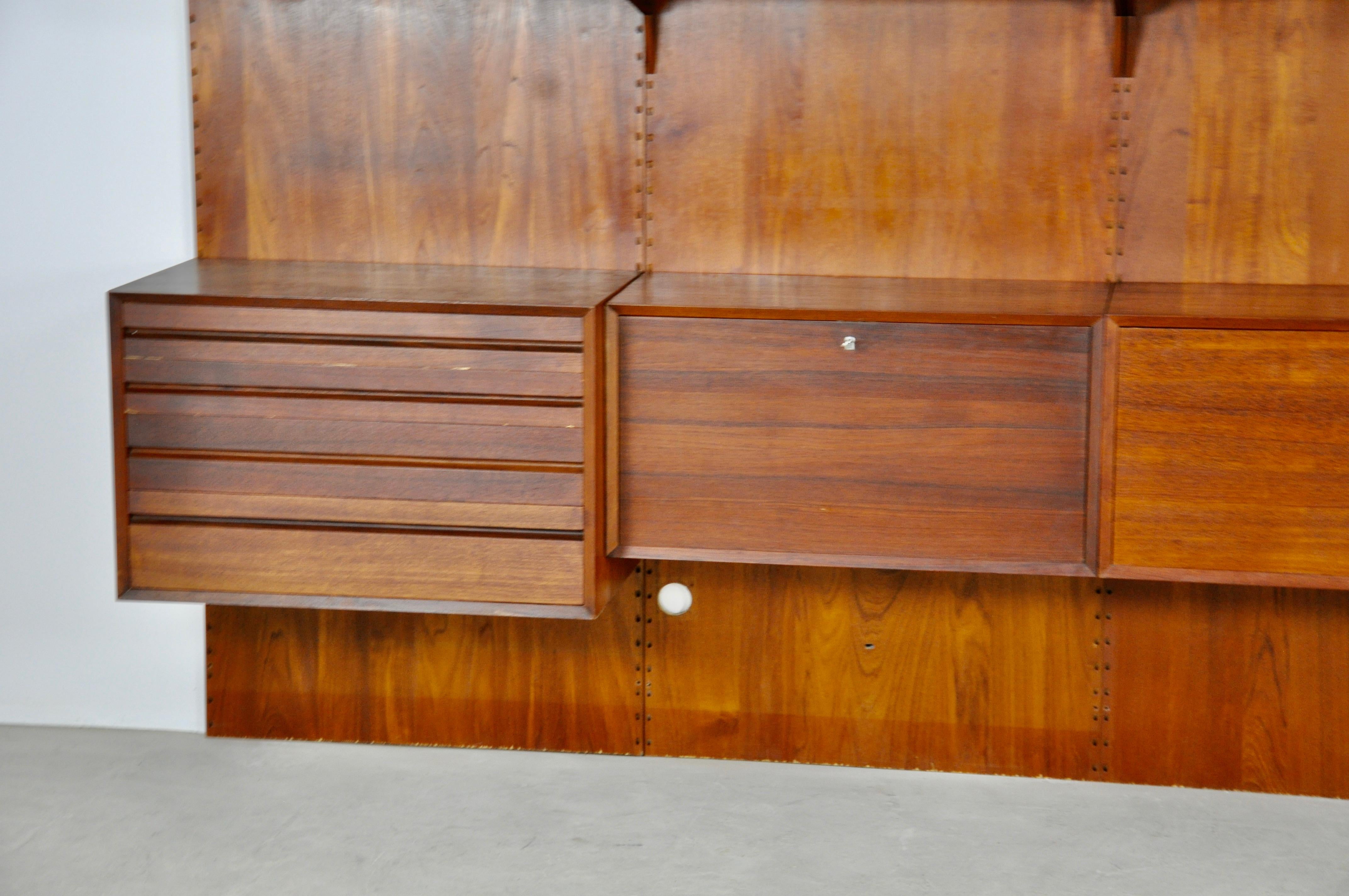 Wall unit composed of 10 boards, 4 back panels and 6 boxes. Wear due to time and age of the wall unit.