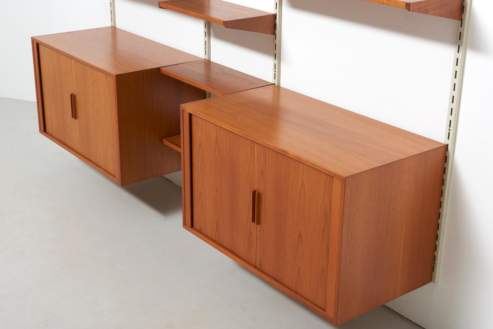 A wall unit in teak. Design by Kai Kristiansen in circa 1960. Made by FM (Feldballes Møbelfabrik) in Denmark.