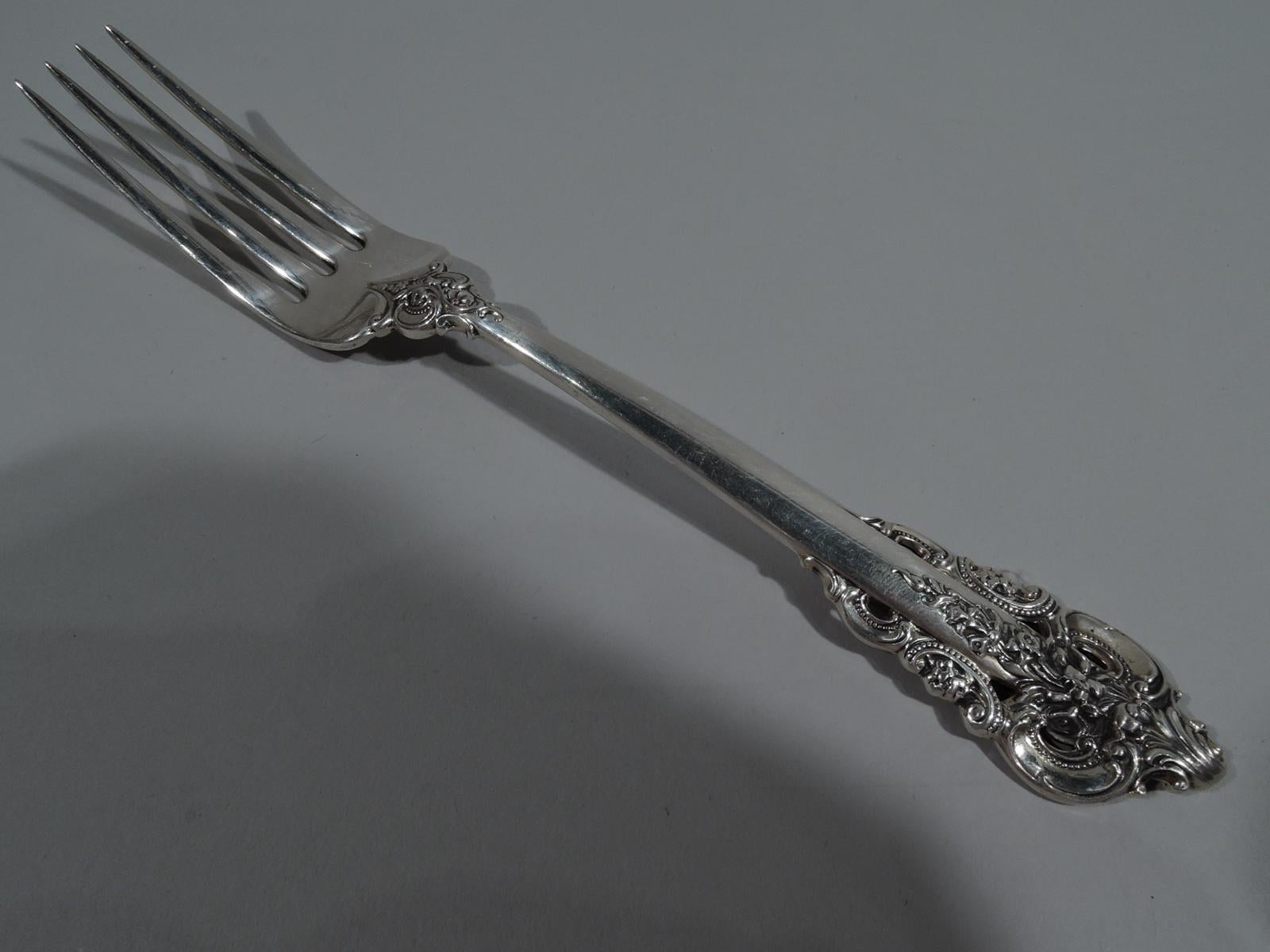 Sterling silver set for 12 in Grande Baroque pattern. Made by Wallace in Wallingford, Conn. This set comprises 52 pieces (dimensions in inches): Forks 12 regular forks (7 1/2) and 12 salad/dessert forks (6 1/2); knives 12 regular knives (9) and 2