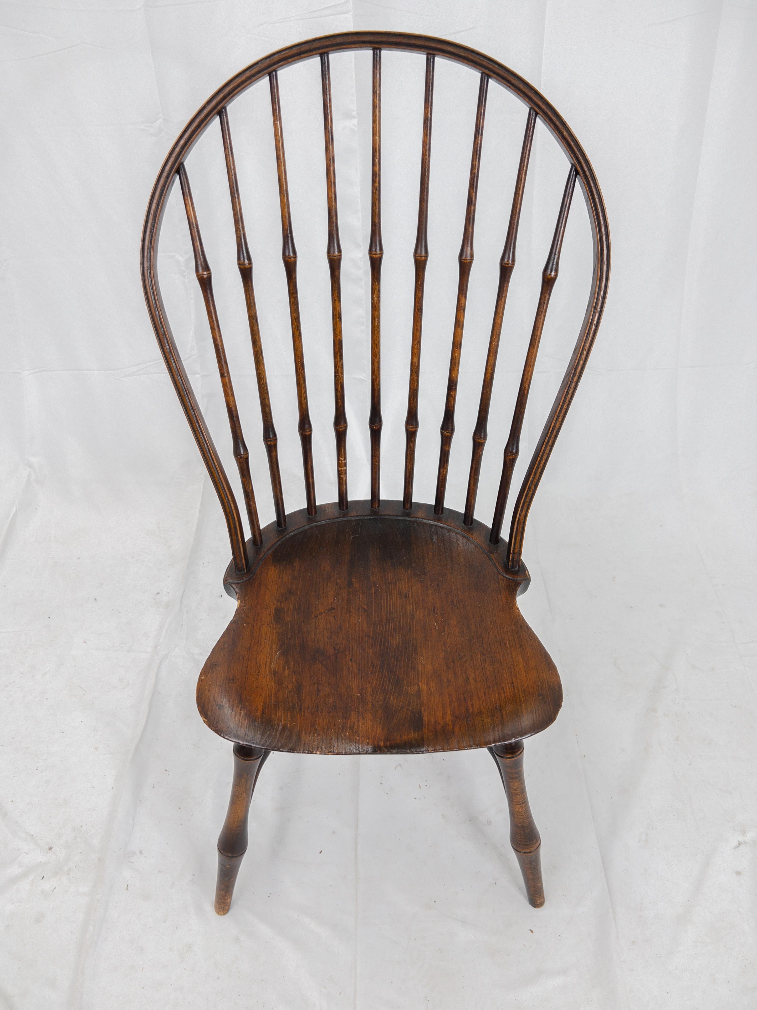 Wallace Nutting Vintage bow back Windsor side chair with a saddle seat and splayed legs.